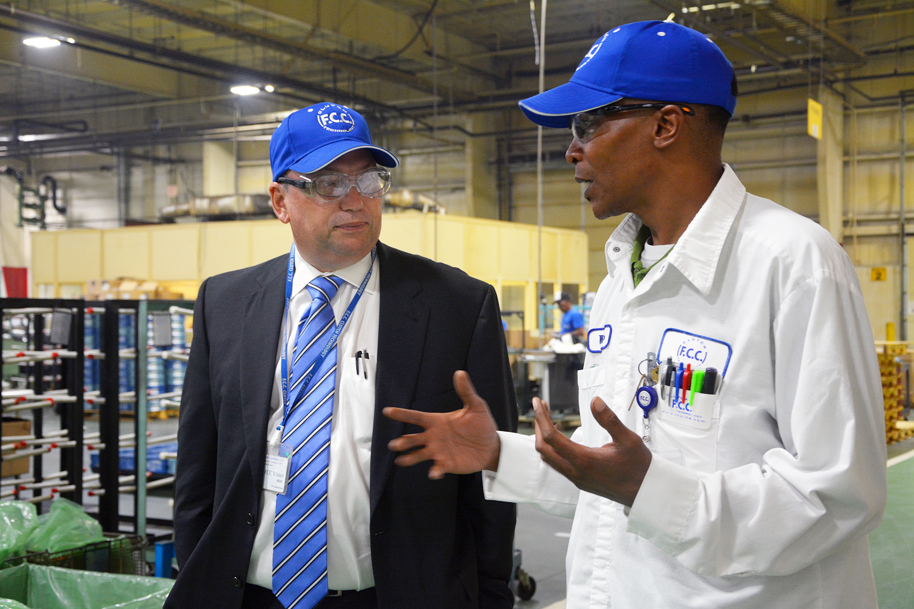FCC Administration Manager Wayne Cromartie, right, describes to Dr. Dale McInnis, president of Richmond Community College, some of the manufacturing processes that go on in the Laurel Hill plant.