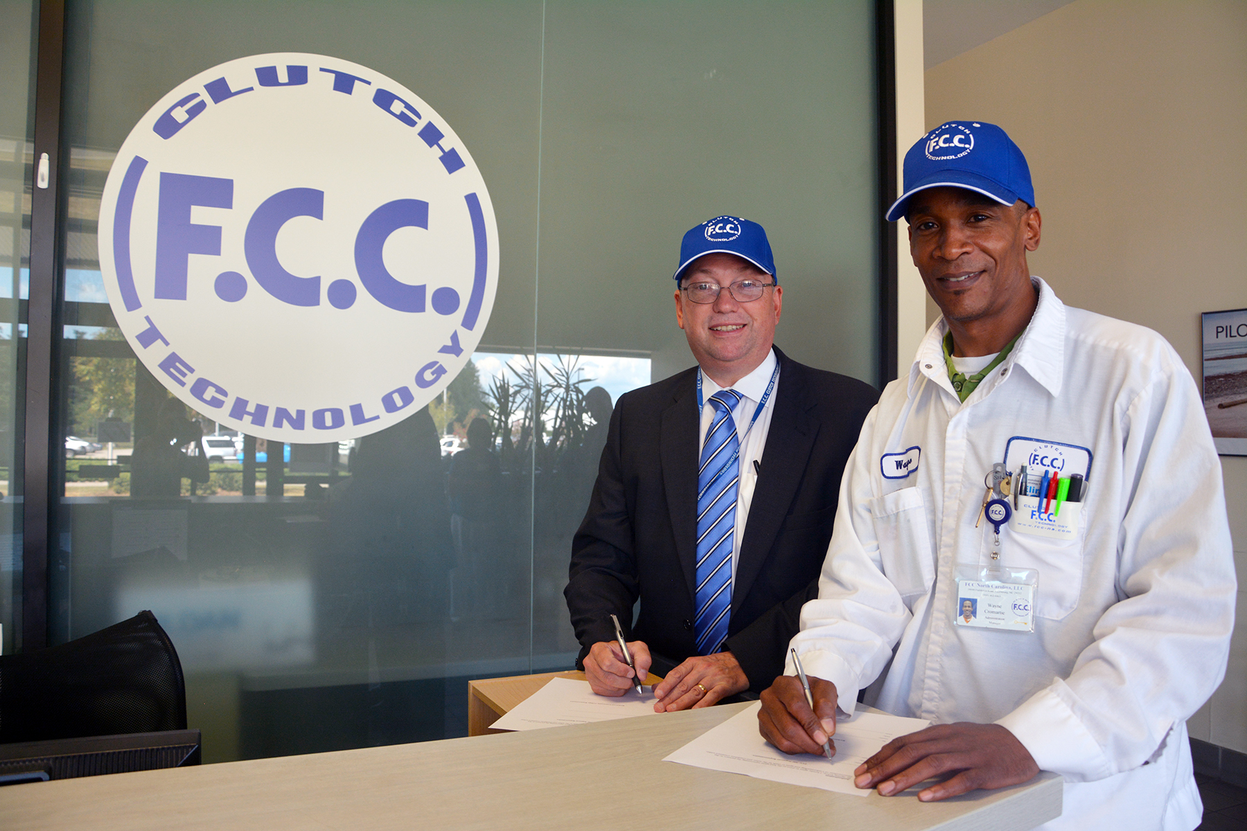 1.	From left, Dr. Dale McInnis, president of Richmond Community College, and FCC Administration Manager Wayne Cromartie sign the paperwork for the various customized training programs the college will be providing to the company.