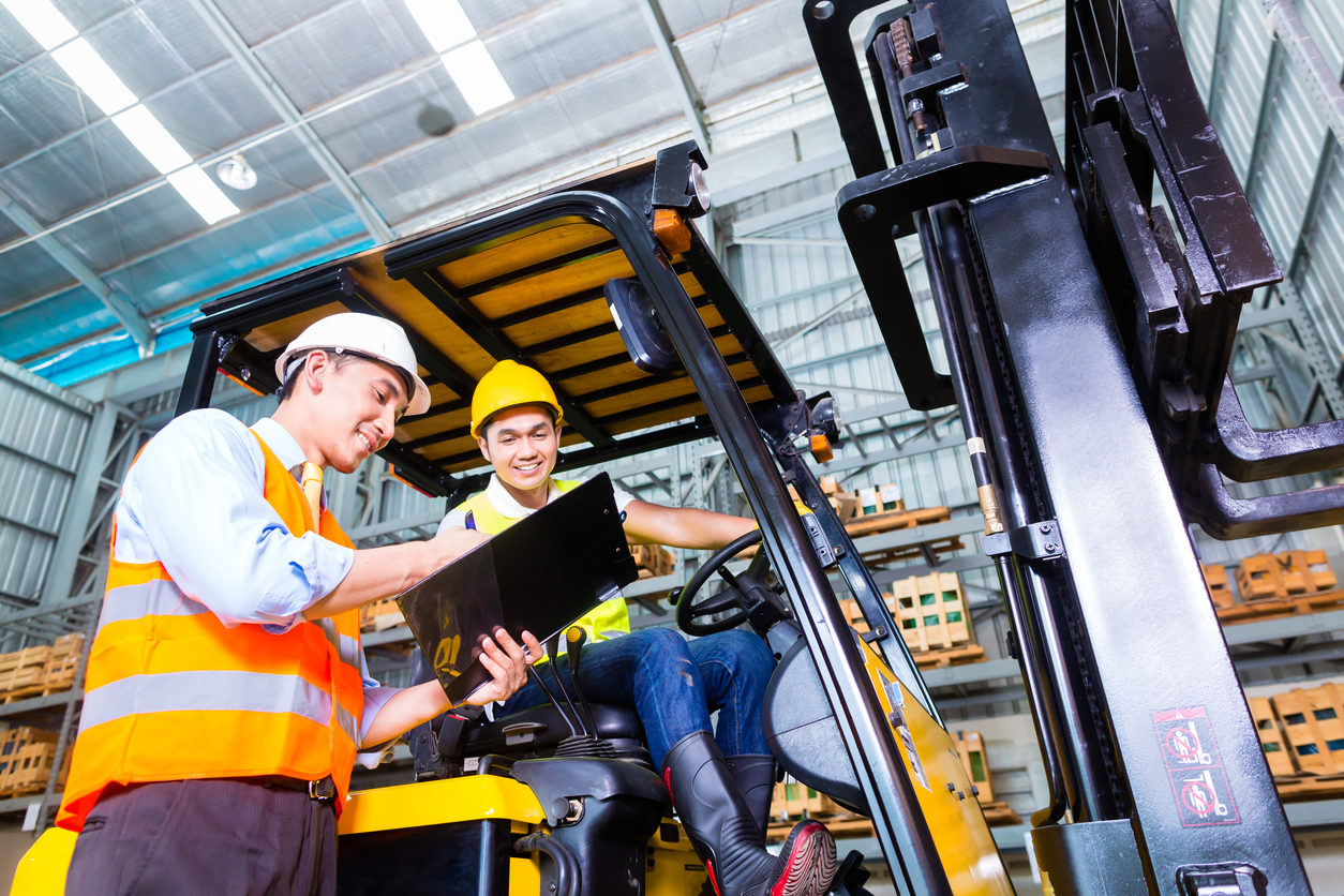 Forklift driver on a forklift with a clipboard in hand