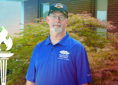 Jimmy Jones wearing a Blue Scoop Building work shirt