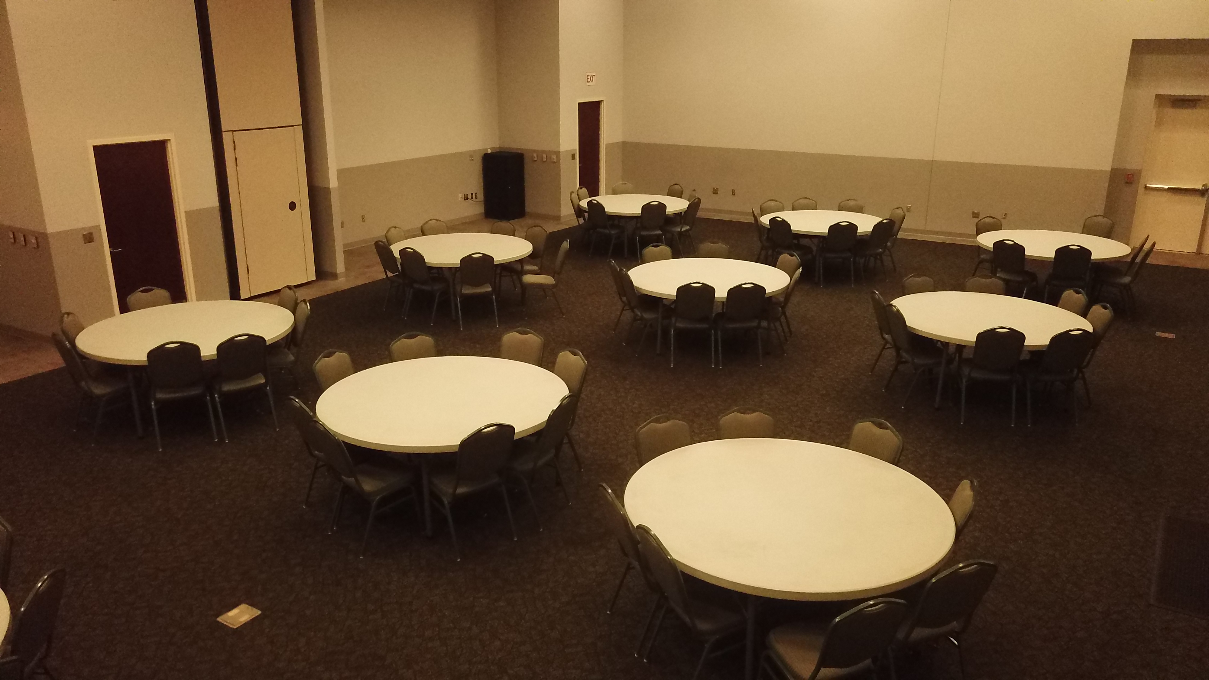 Room with round tables and chairs at tables