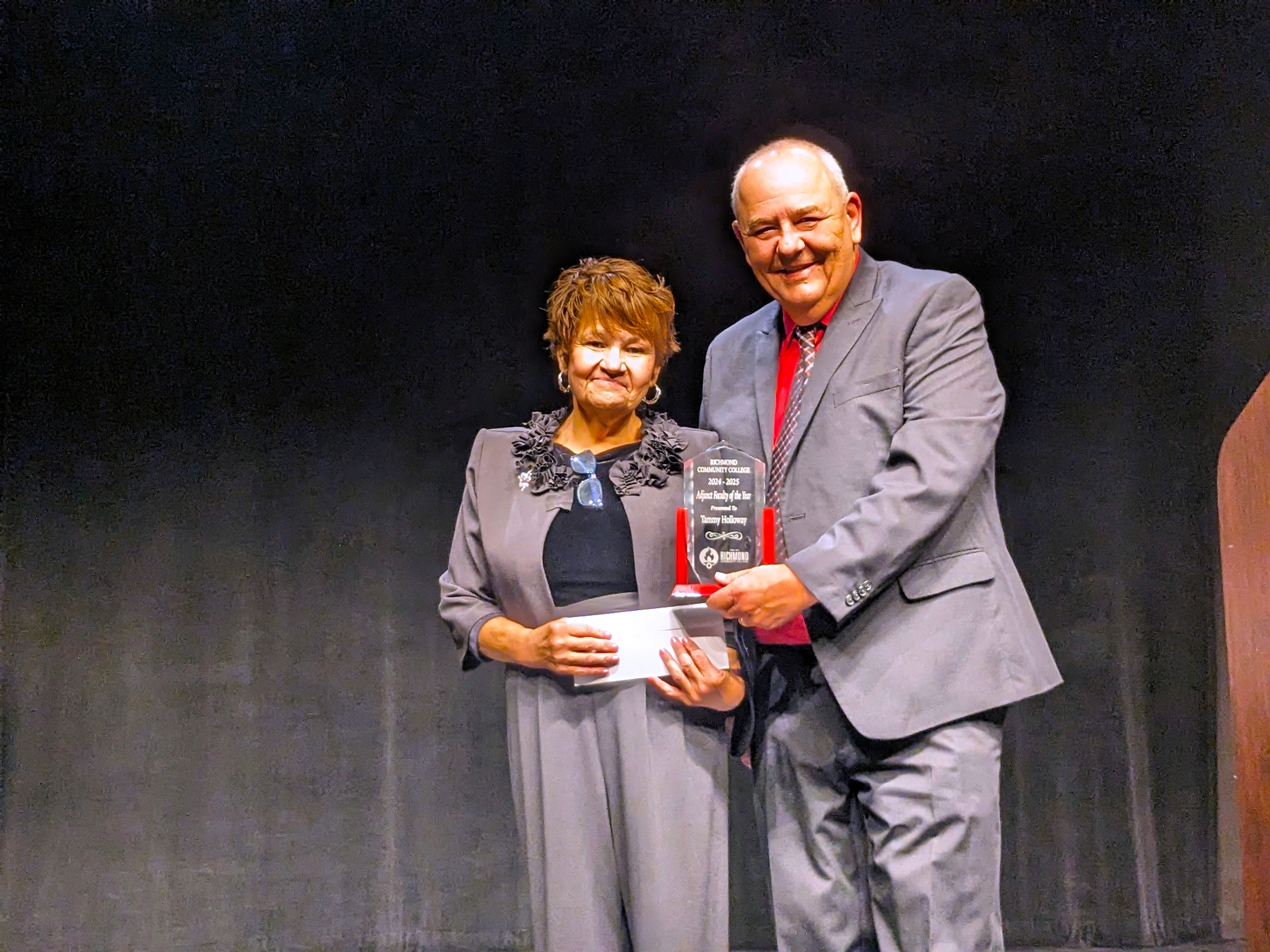 Tammy Holloway accepts award from Kevin Parsons.