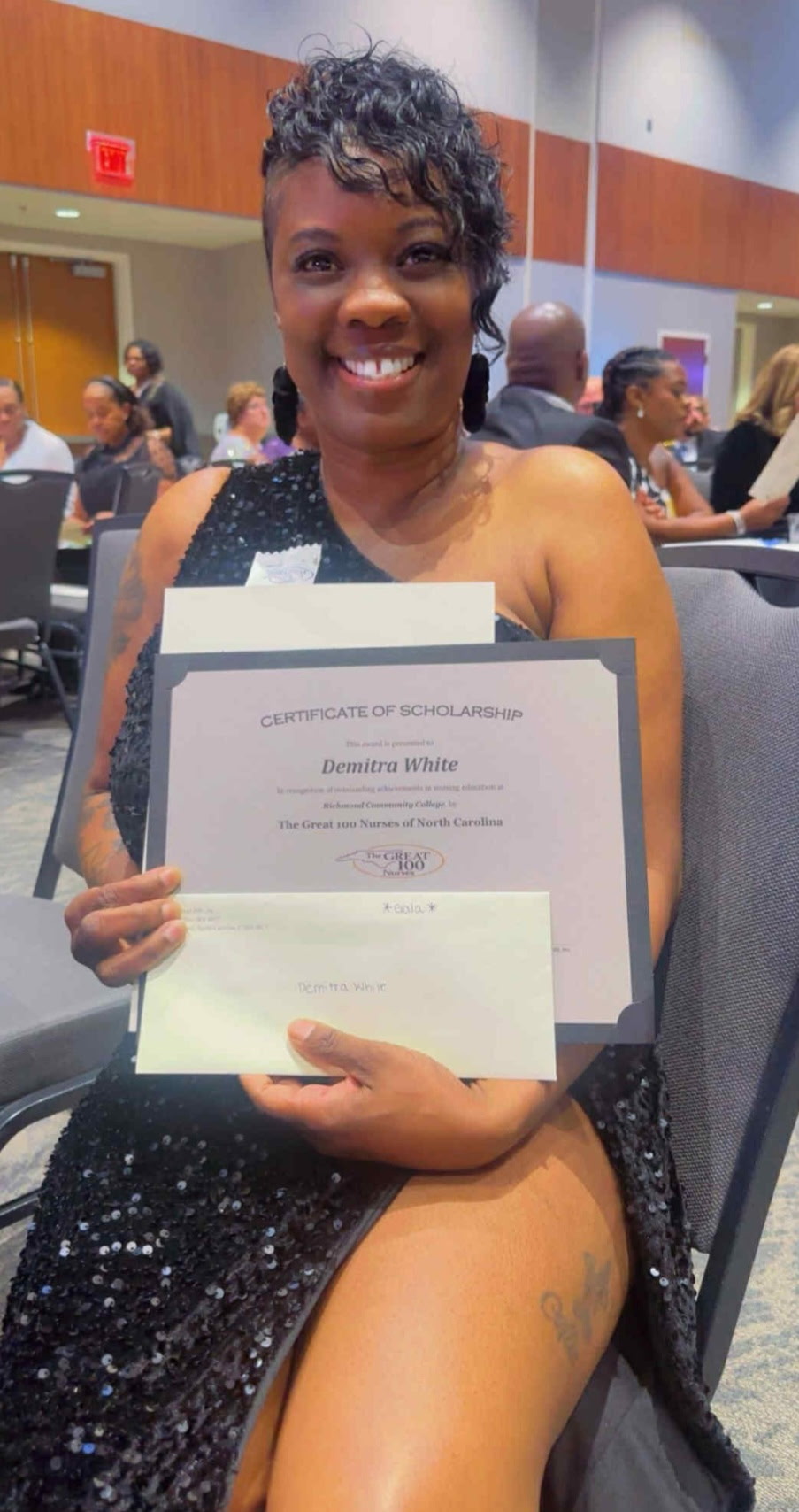Demitra White holds the certificate she received for the 100 Great Nurses of North Carolina Scholarship.