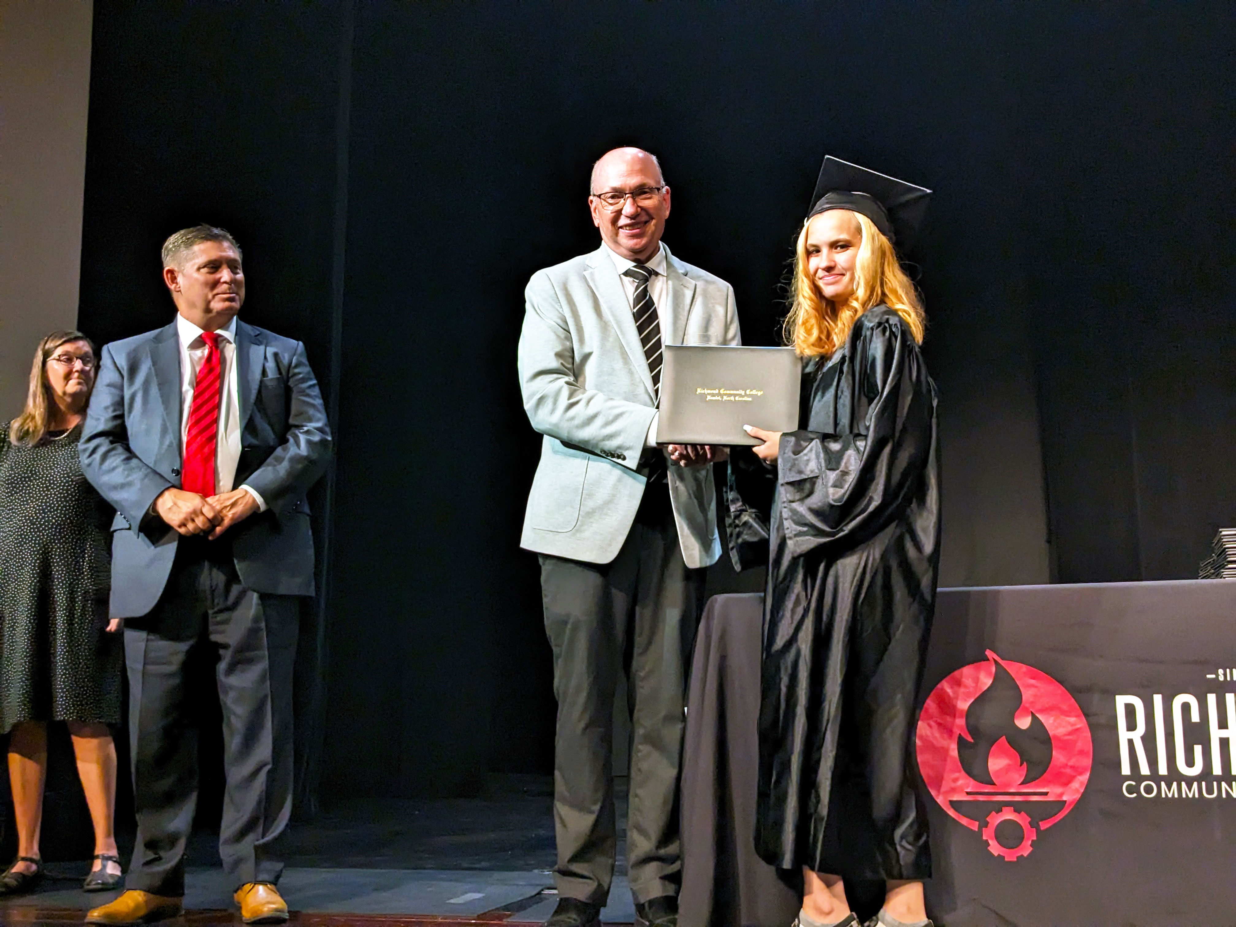 Adult High School graduate receives diploma.