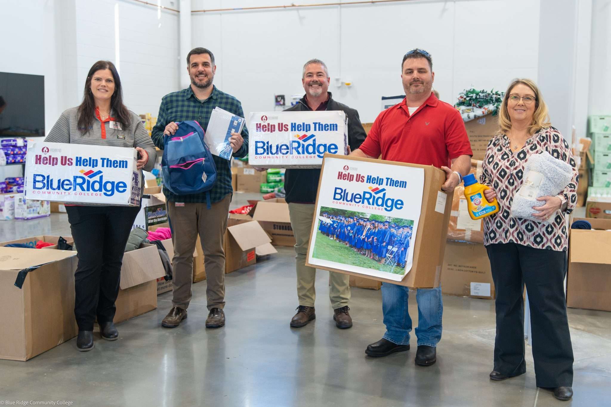 A group holds donated boxes to Blue Ridge Community College