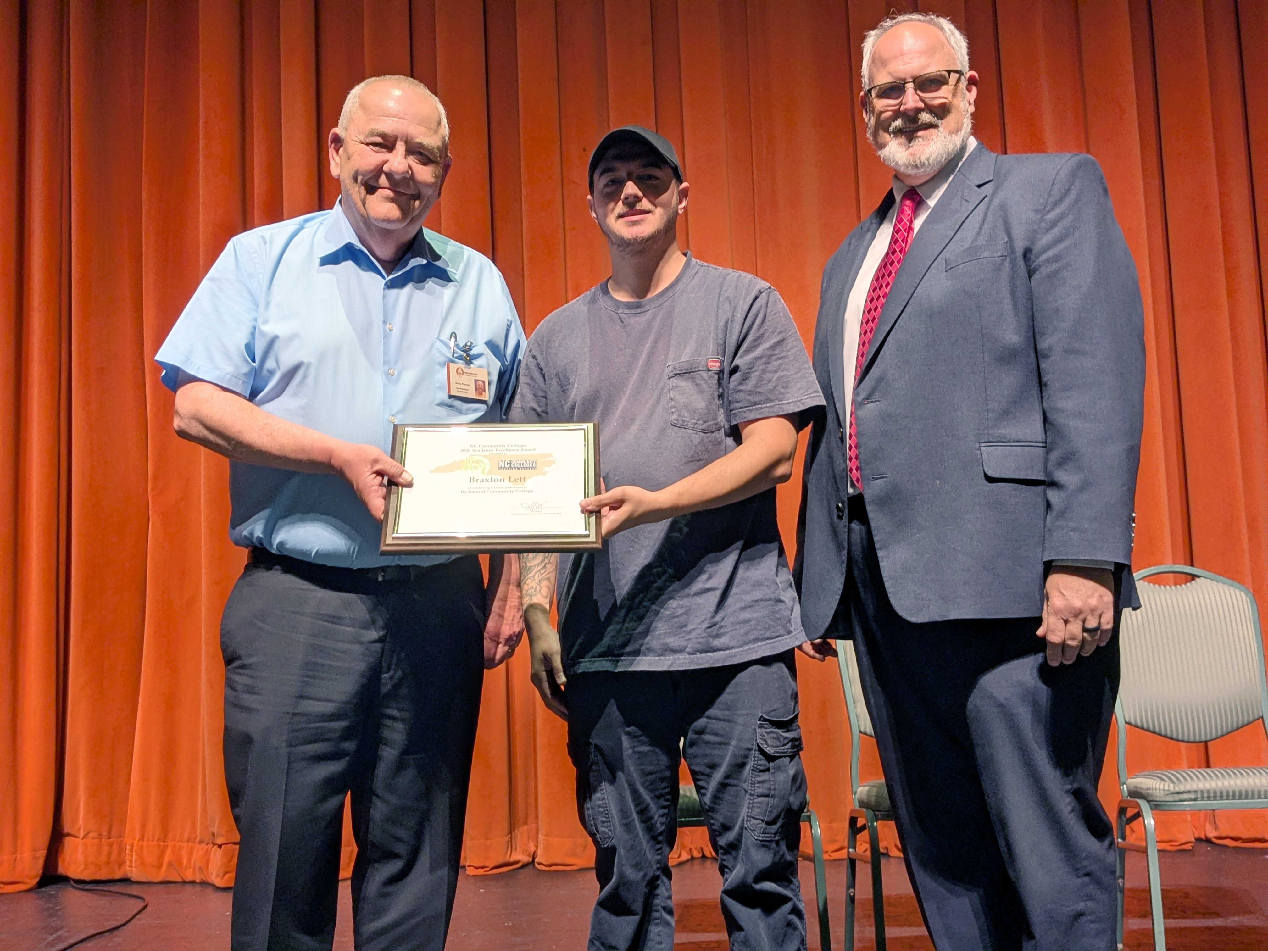 Academic Excellence Award winner accepts the award from RichmondCC leaders.