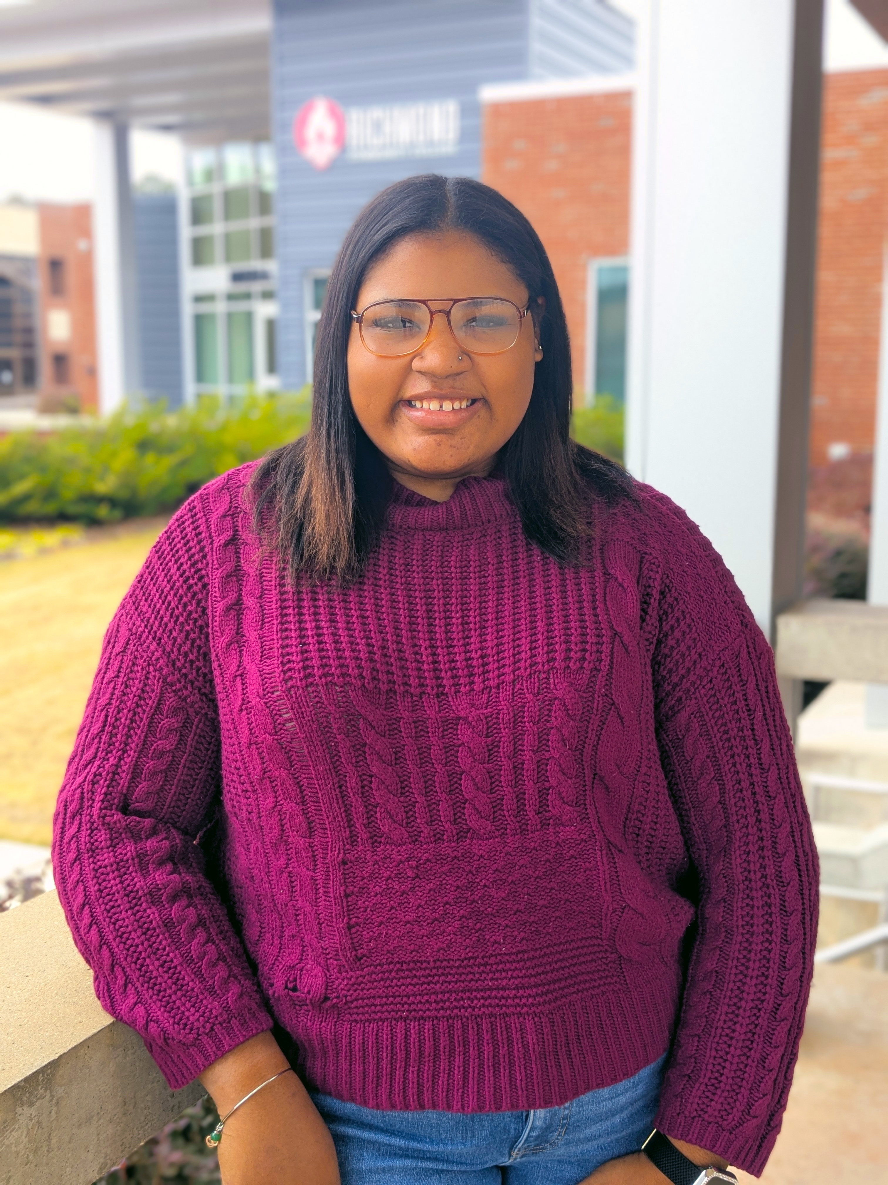 Caitlynn Hunt poses for a photo in front of the Lee Building.