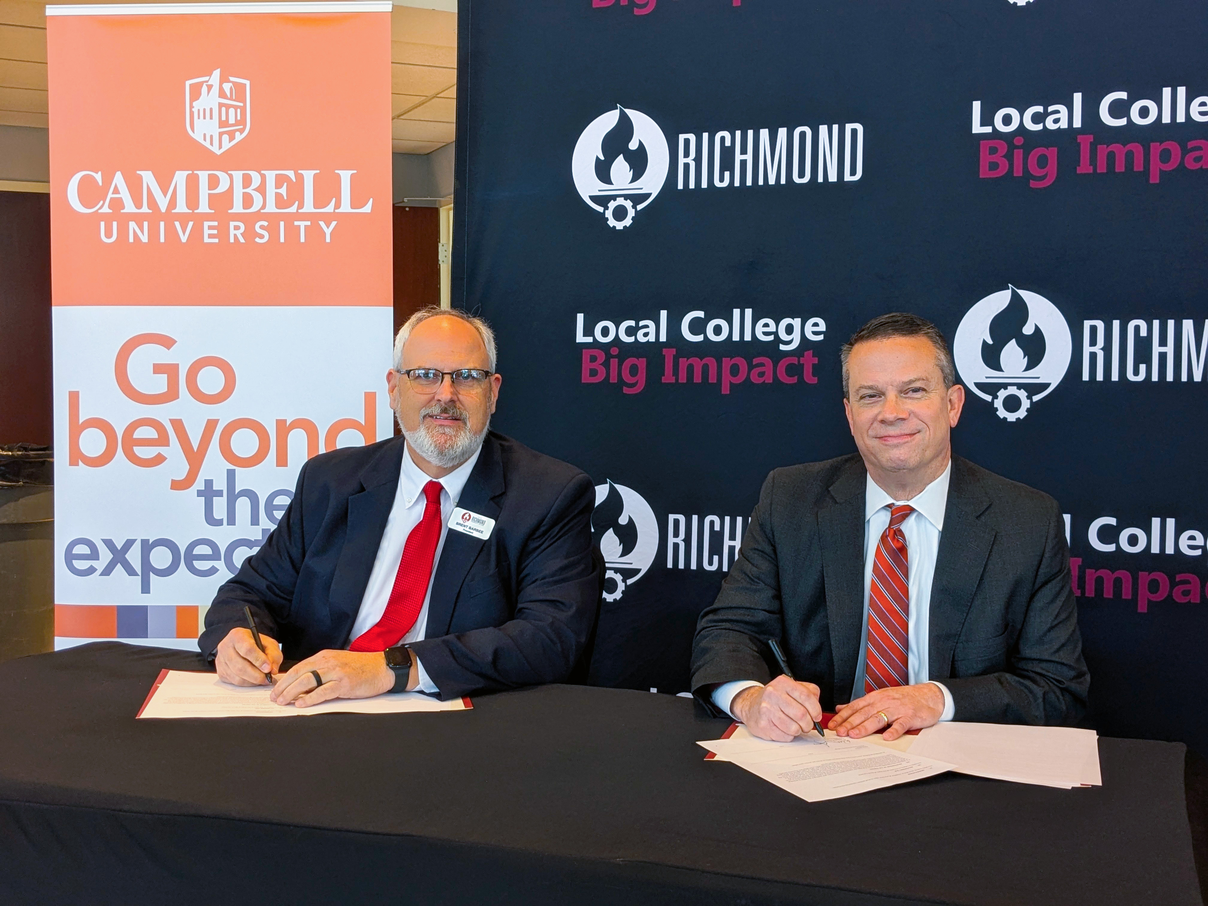 RichmondCC President and Campbell University President sign off on documents.