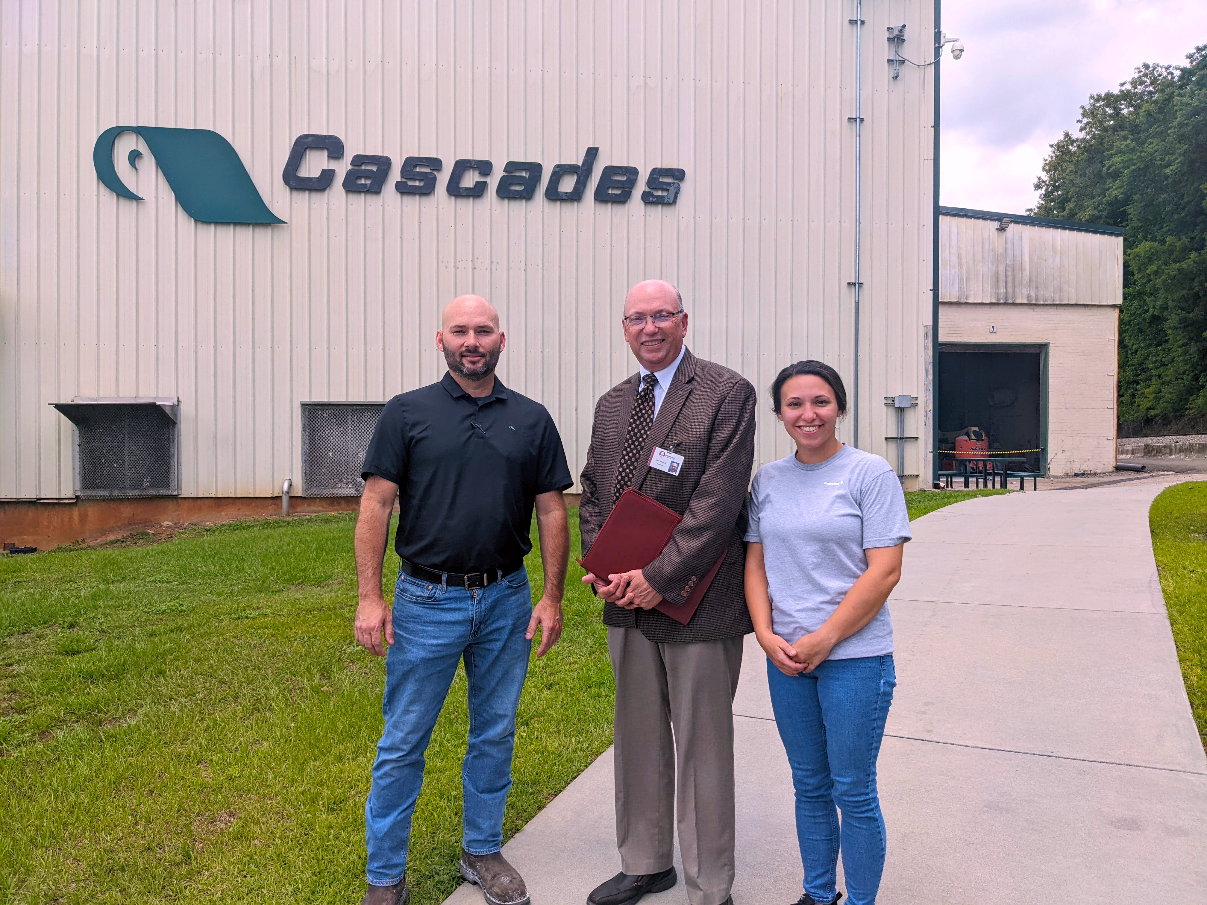 Cascades employees stand with Dr. McInnis in front of Cascades