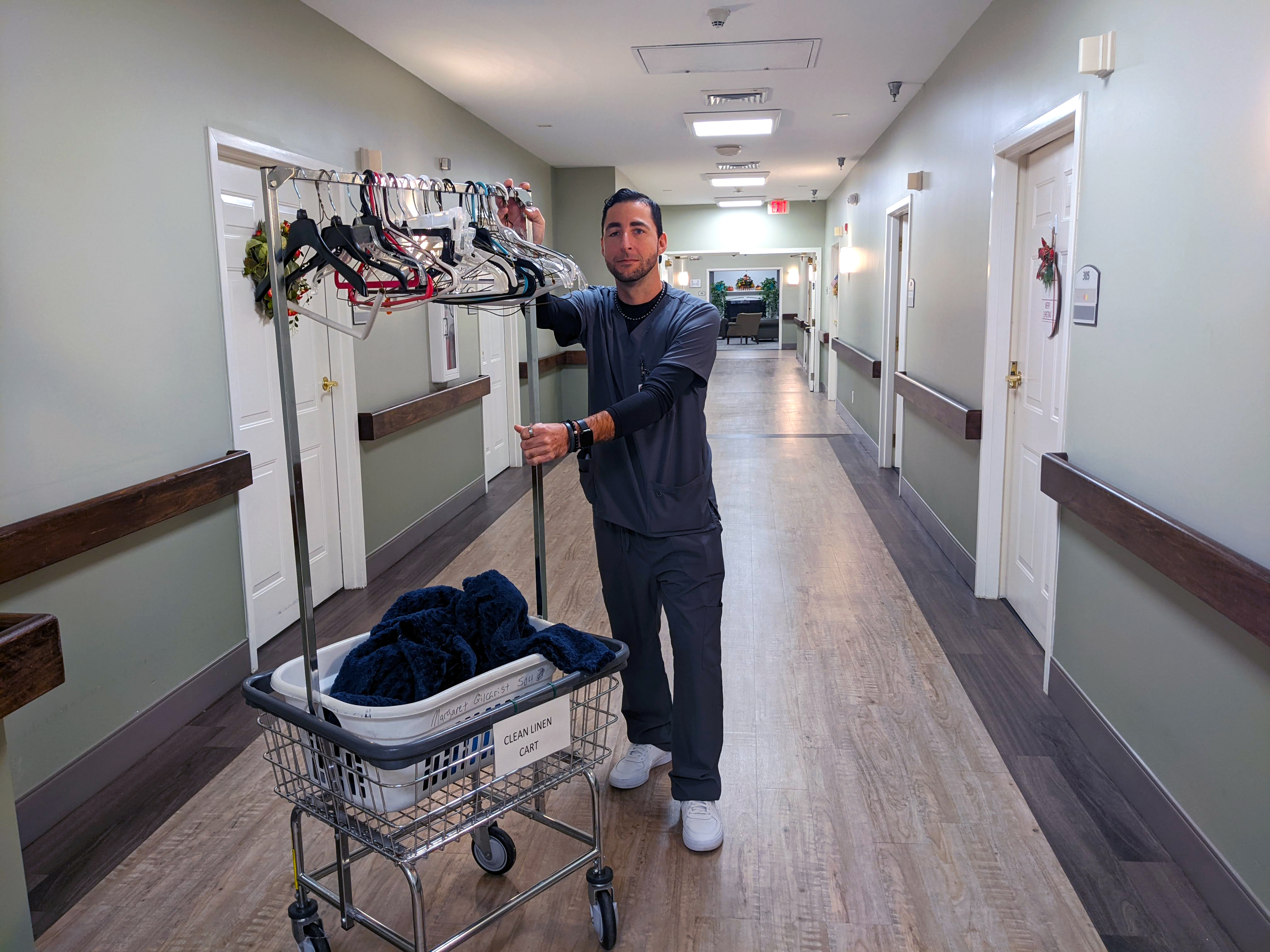 CNA student pushing laundry cart