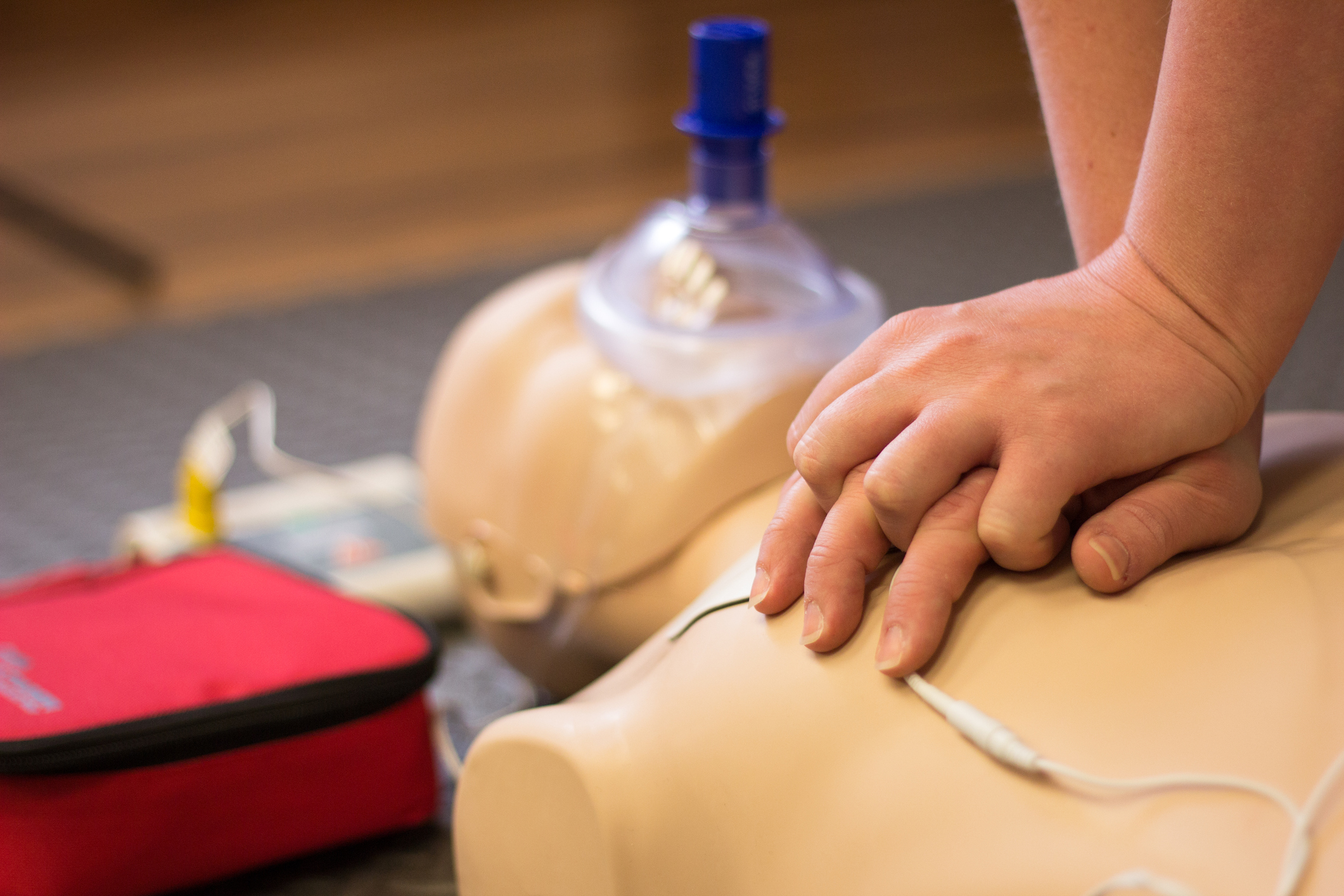 Picture of hands performing chest compressions on a mannequin
