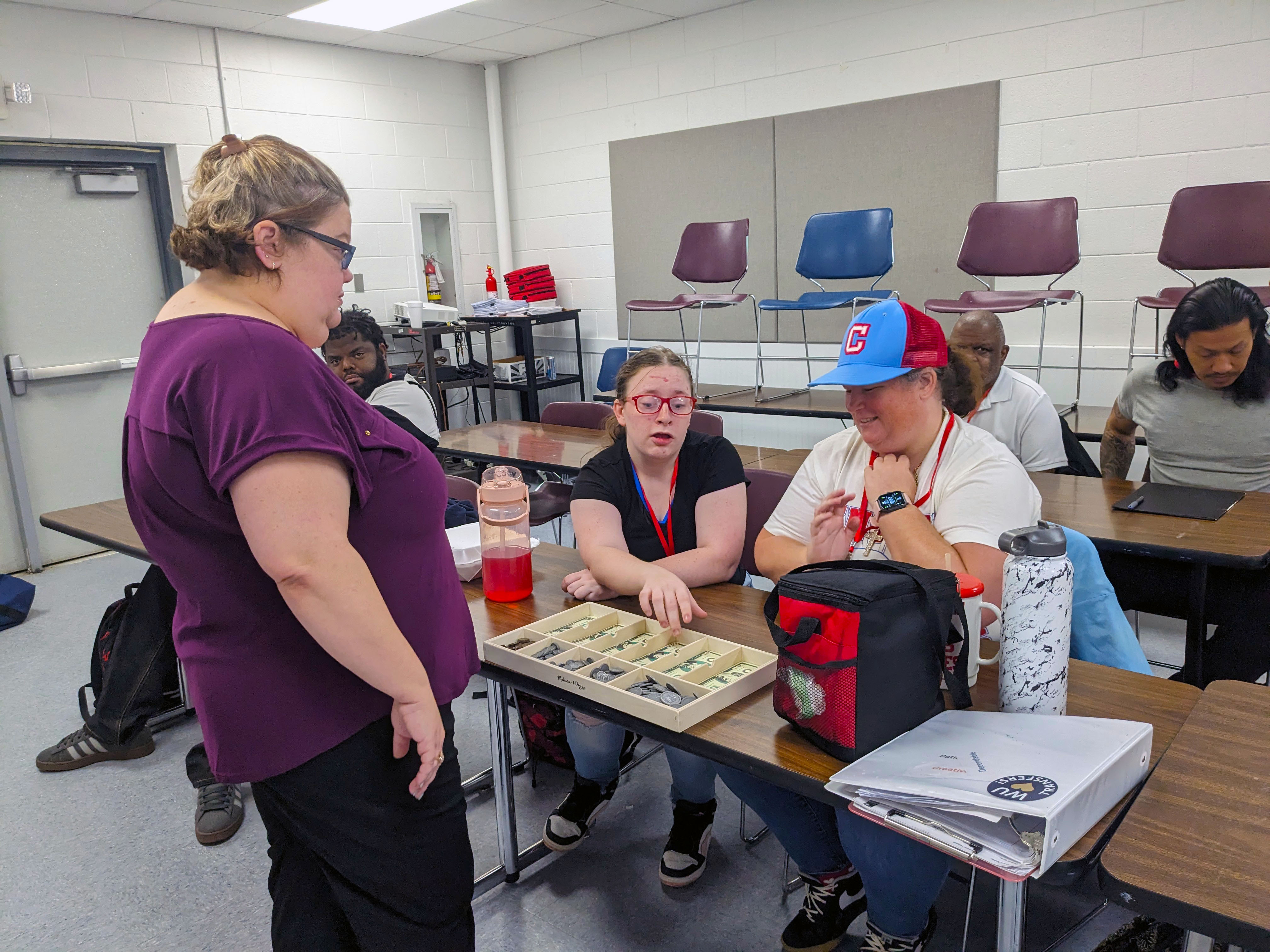 Students in a class learning to count money