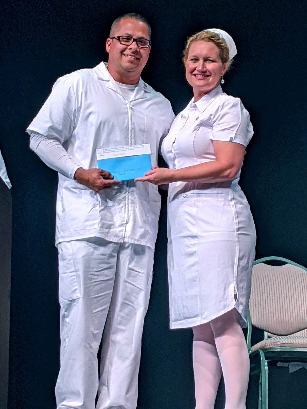 David Collins stands with a nursing instructor during the ADN pinning ceremony.