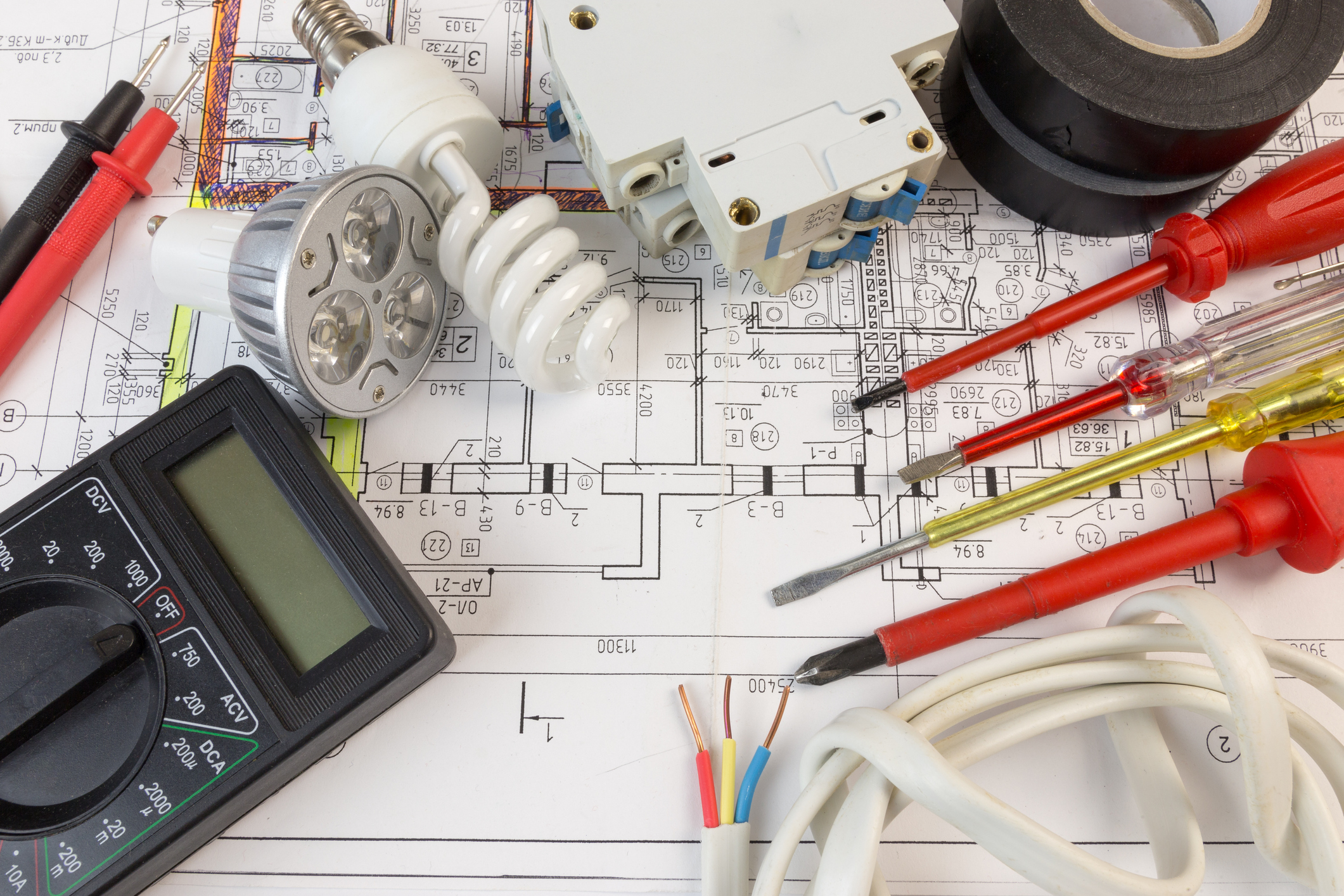 Electrical blueprints and other tools of an electrician
