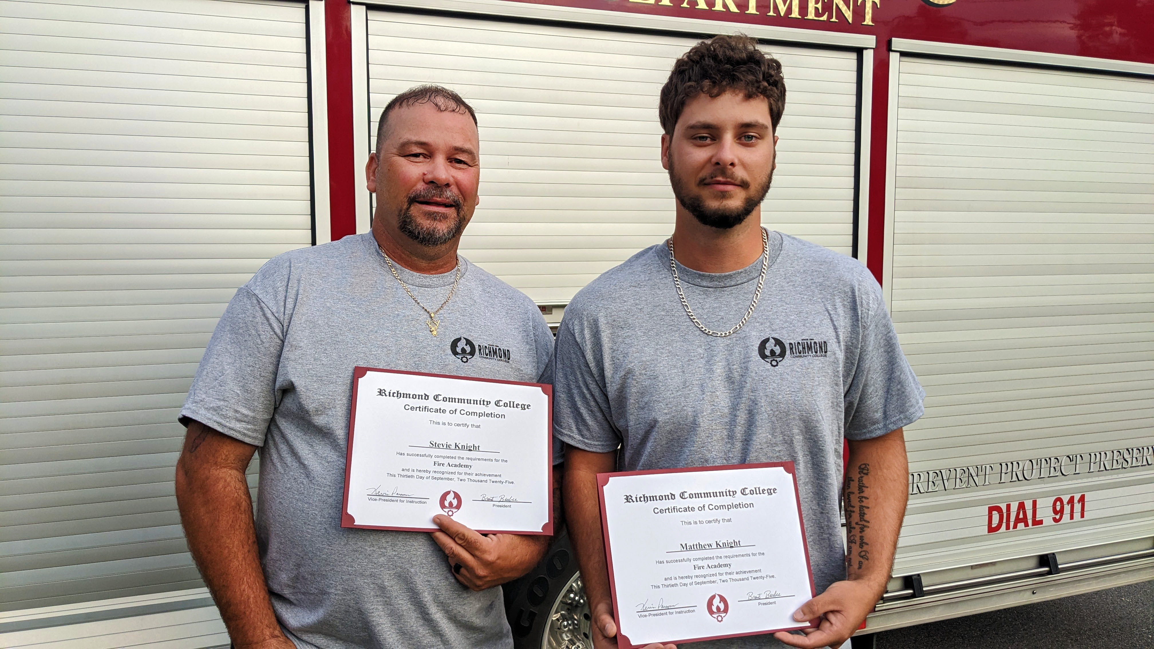 Stevie and Dawson Knight hold their Fire Academy completion certificates.