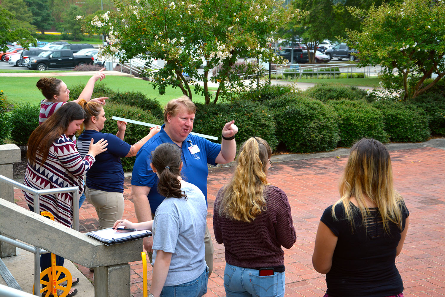 Instructor Carl Howald talks to students standing outside the Lee Building
