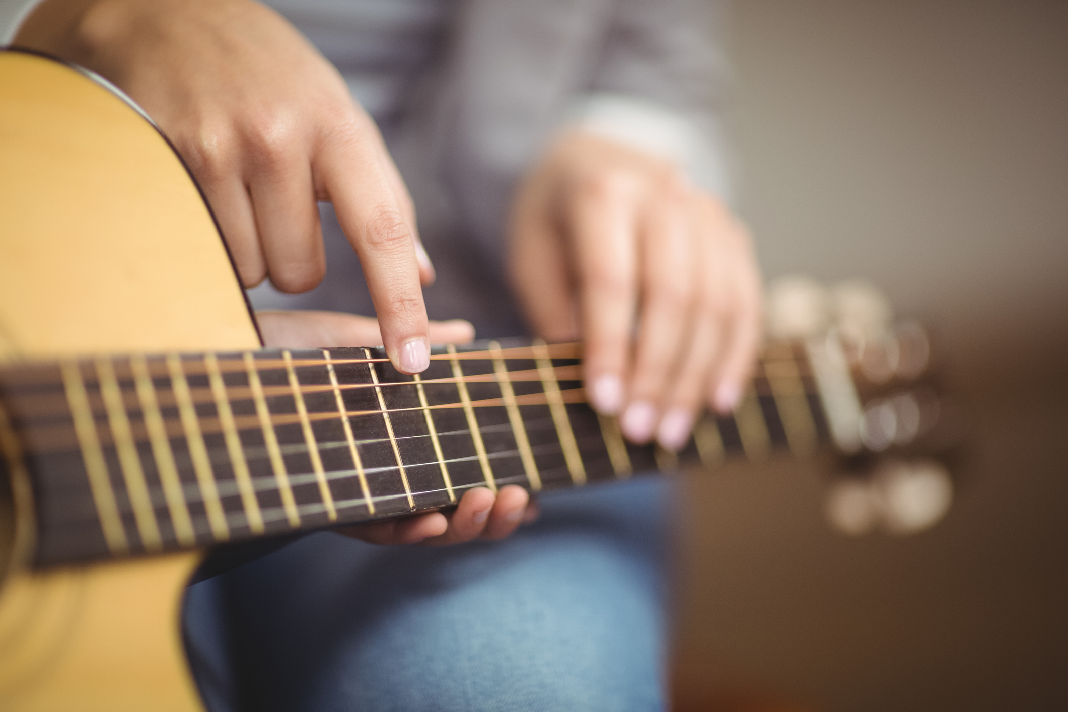 Person's hands holding a guitar