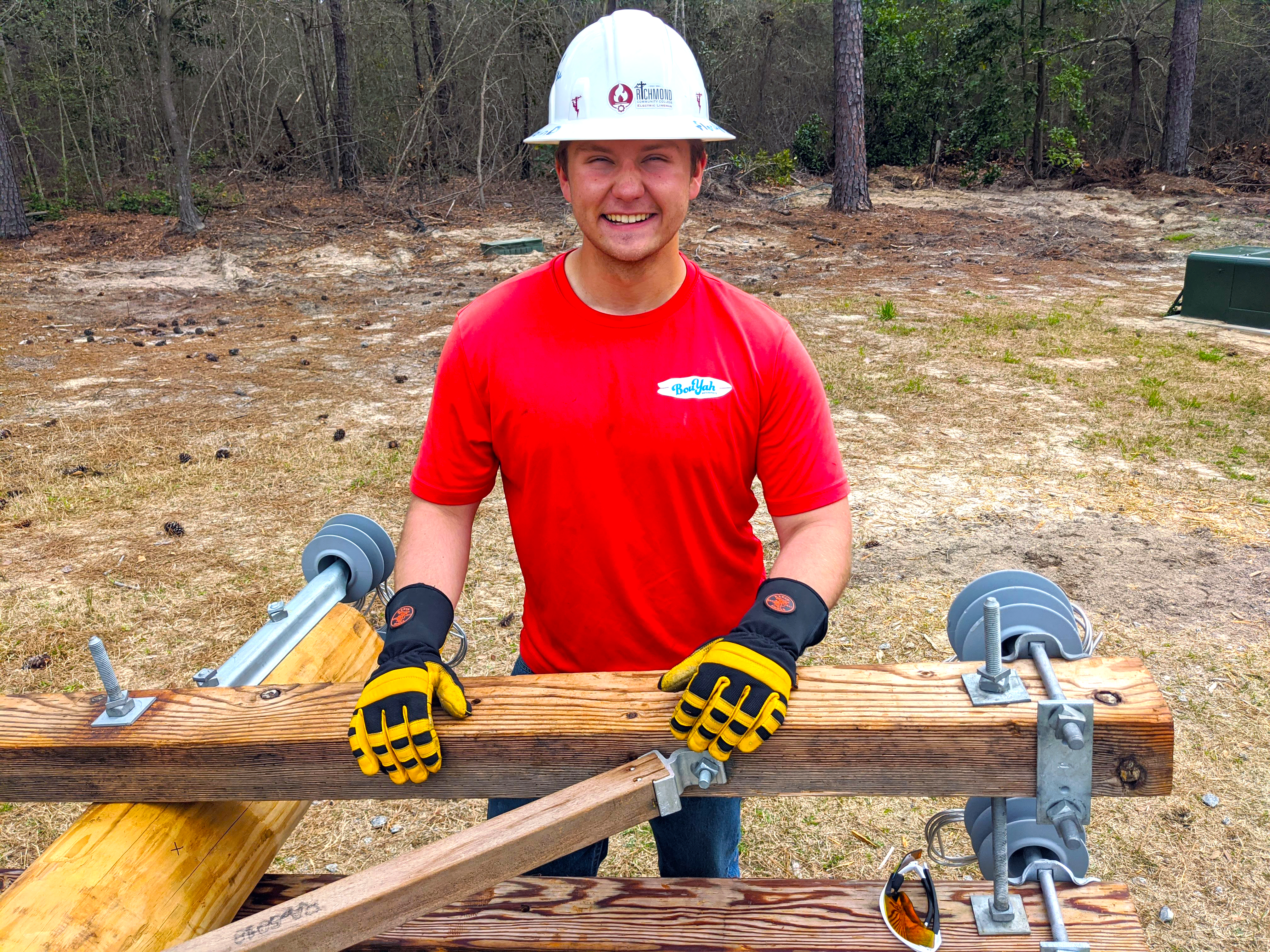 Jason Blevins stands by a utility pole on the ground