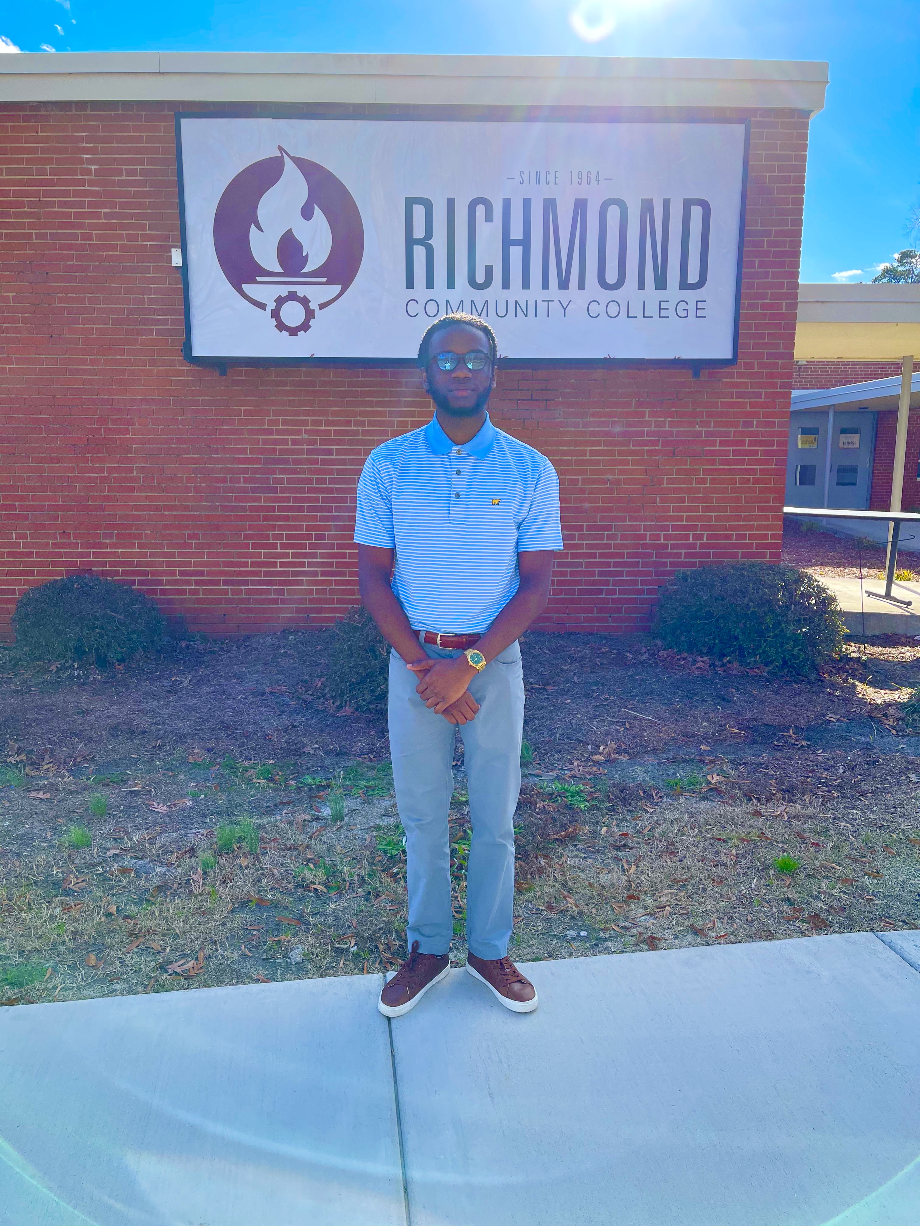 Jordan McQueen stands by building with RichmondCC logo