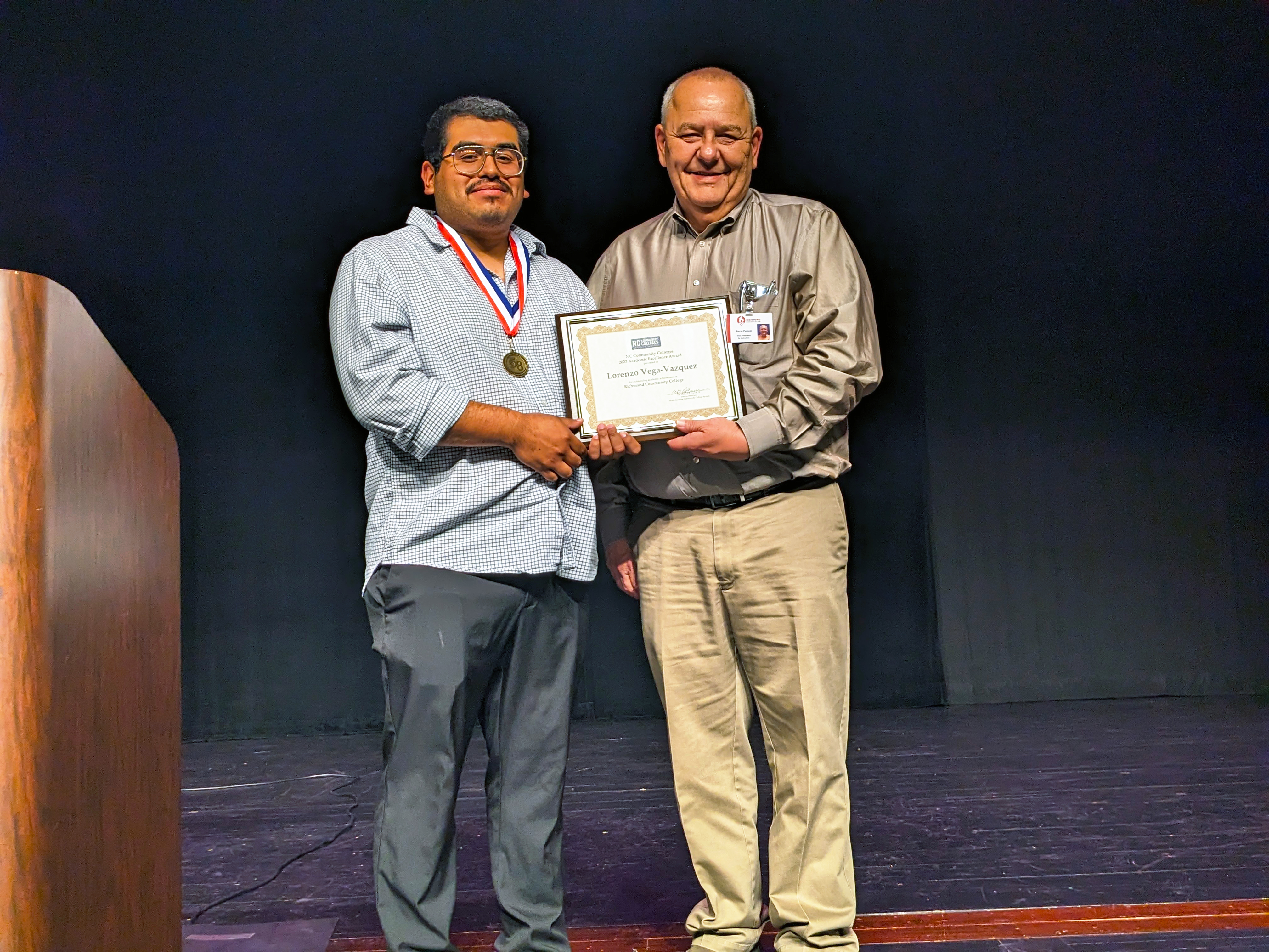 Student and vice president standing on stage