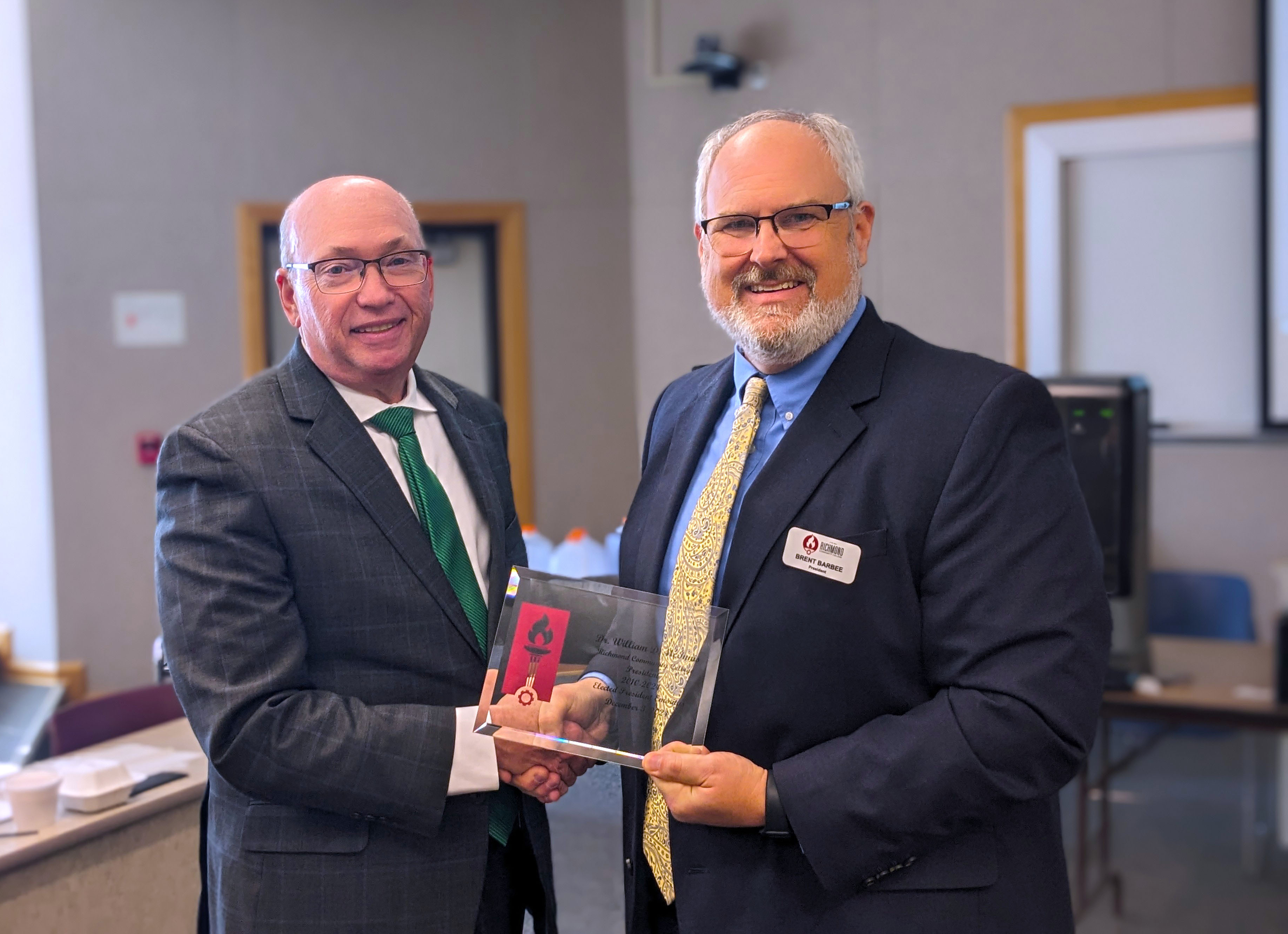 Dr. Dale McInnis accepts an award from President Brent Barbee