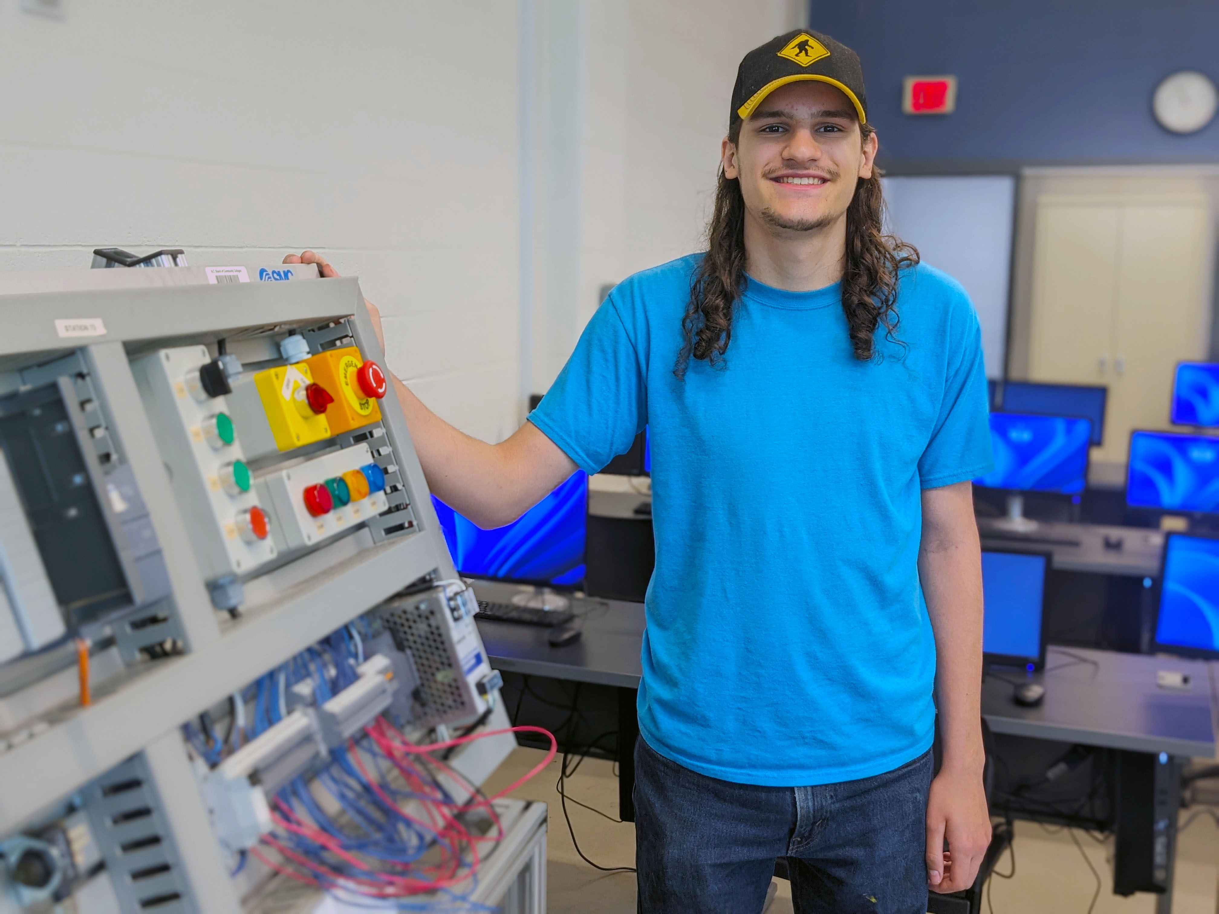 Mechatronics student Constantine Amoroso stands in the Automation Lab.