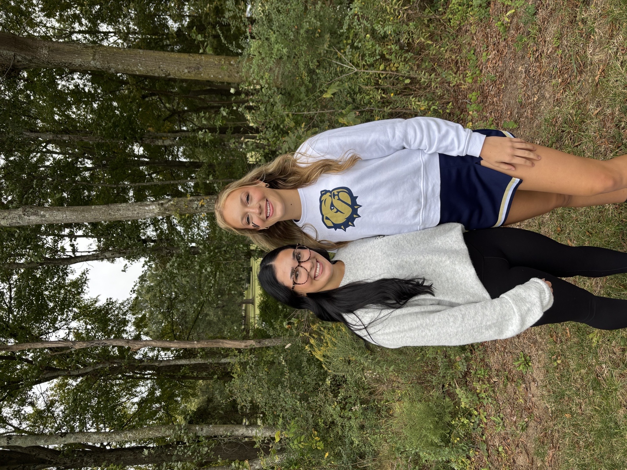 Mikayla English stands next to her roommate.