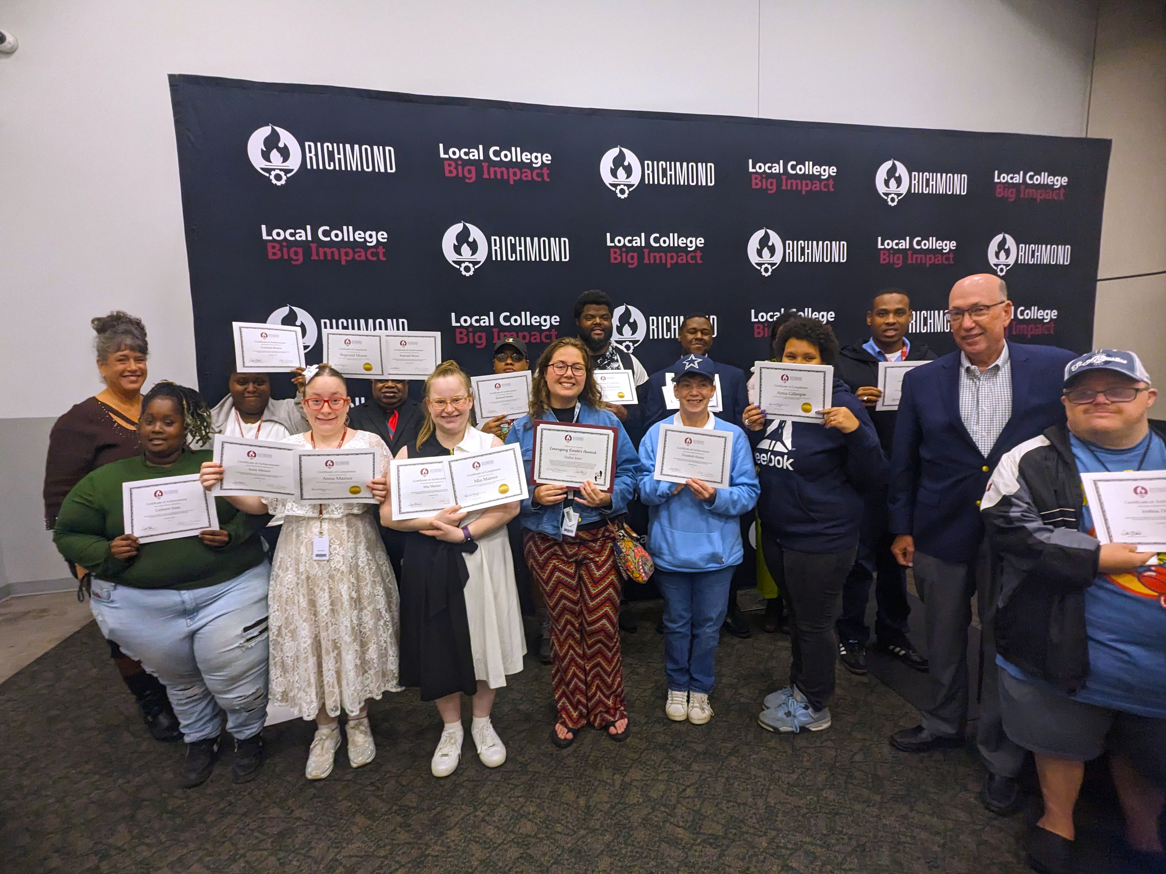 Next Steps students hold up their certificates.