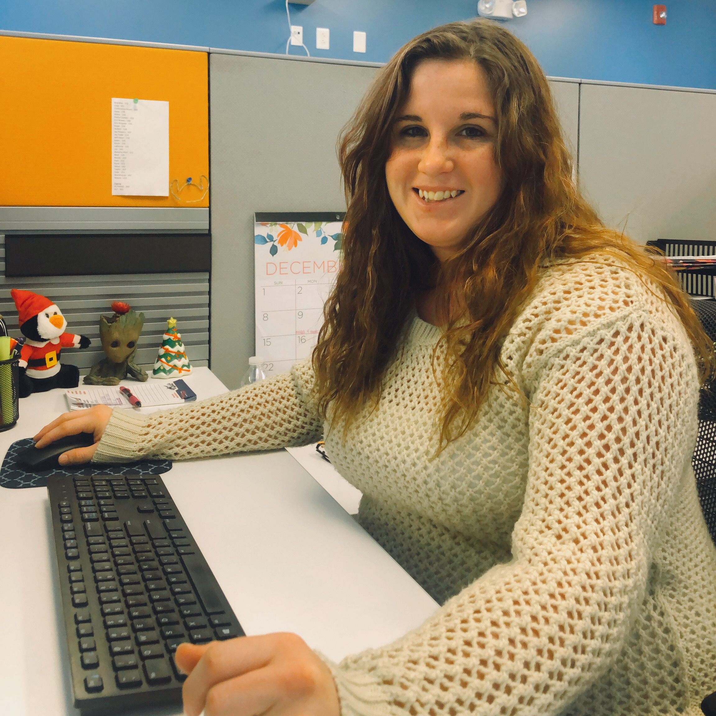 An office administration graduate sits at her computer.
