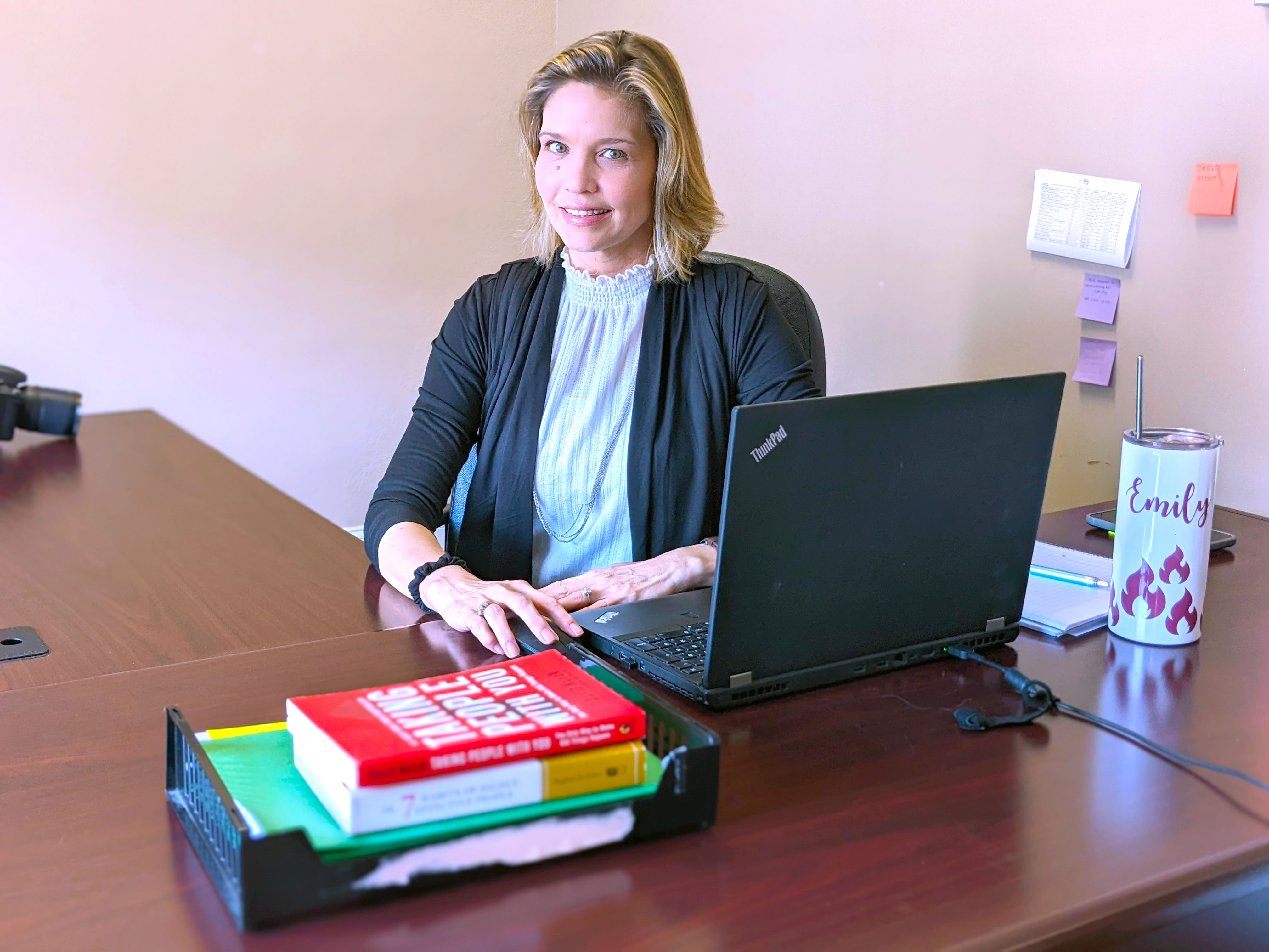 Emily Lamonds-Canter sits at her desk at jer job