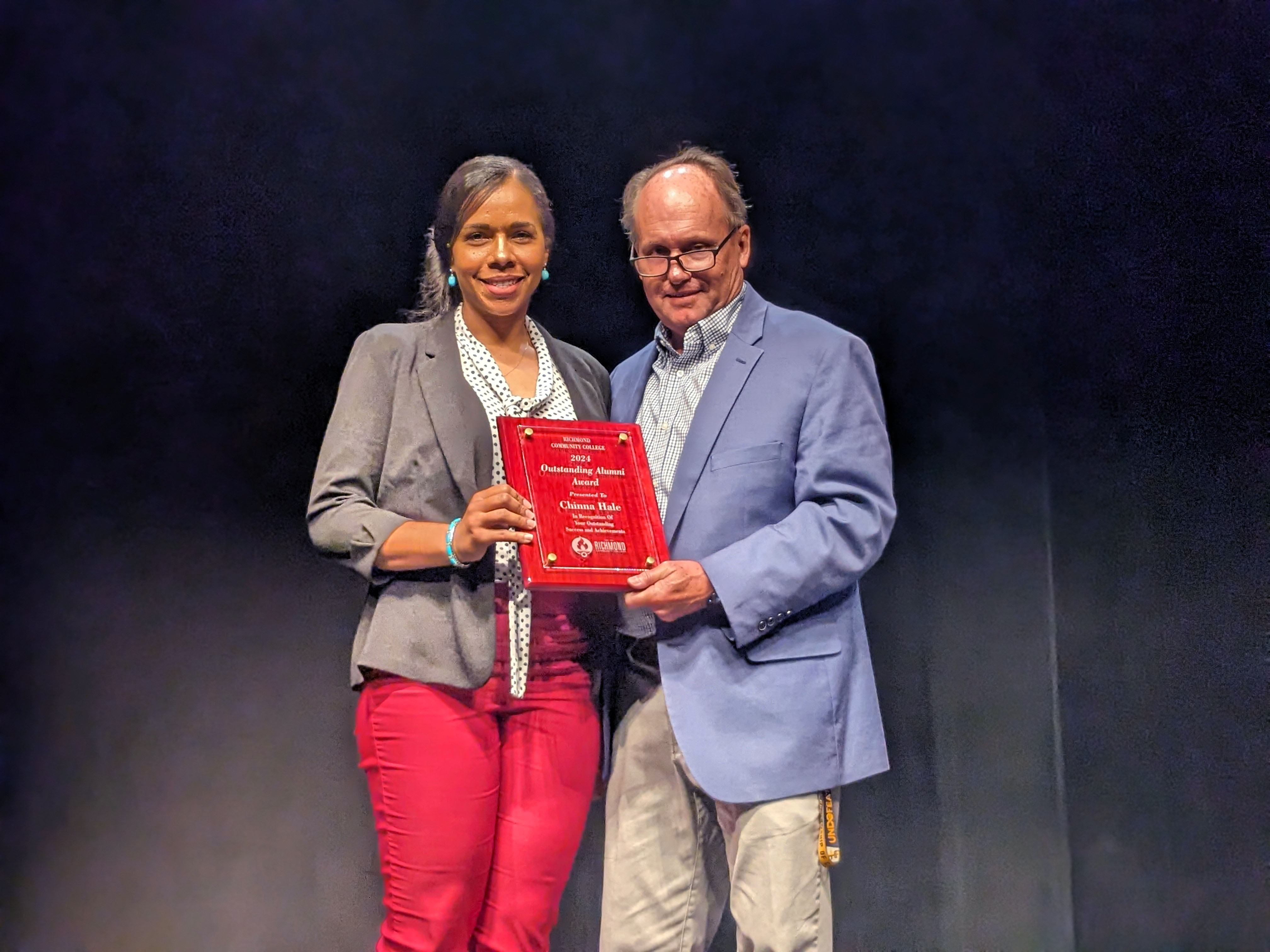 Chinna Hale accepts her award from Dr. Hal Shuler.