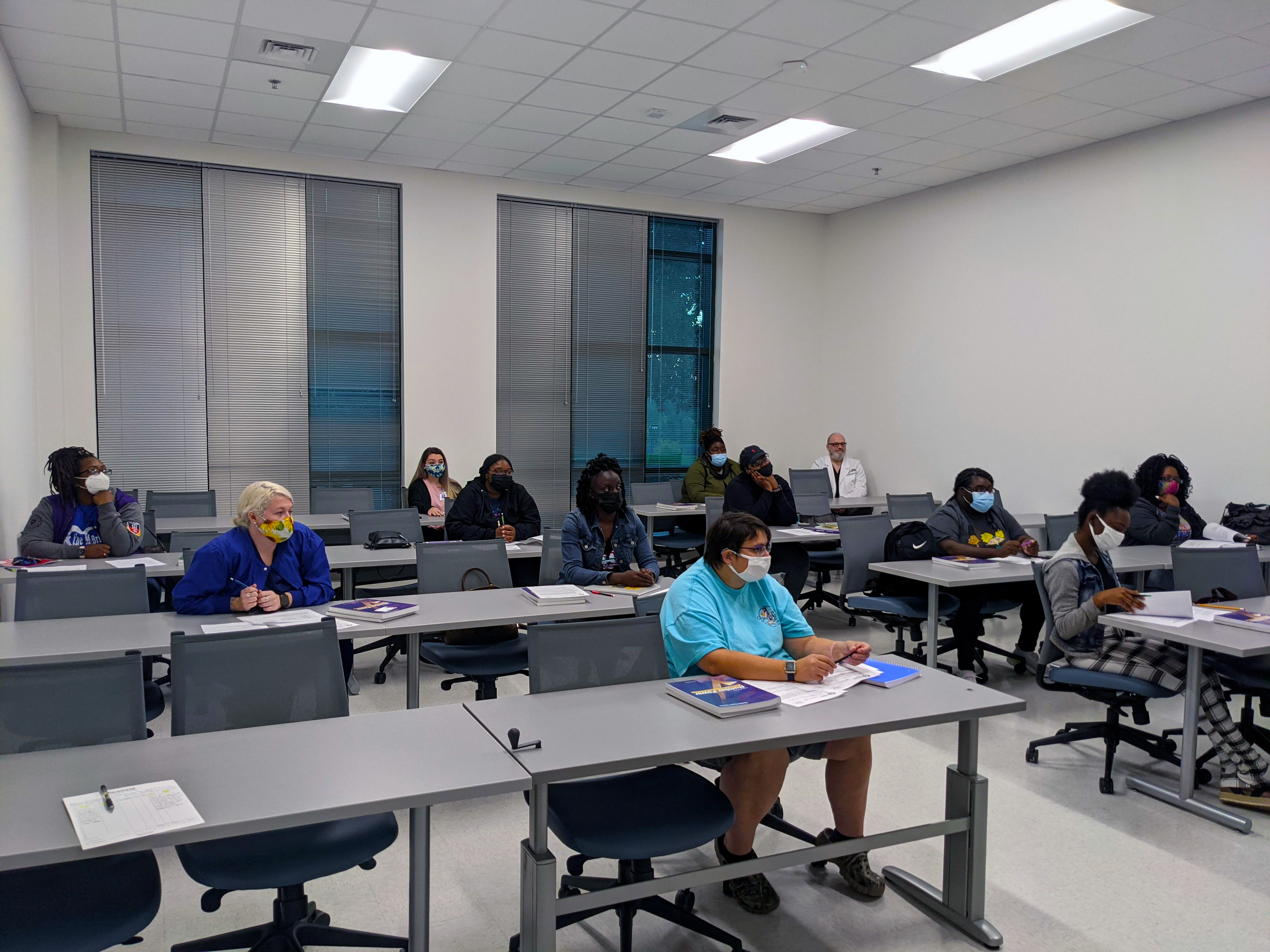 Students in the Pre-Pharmacy Technician class sit in a classroom.