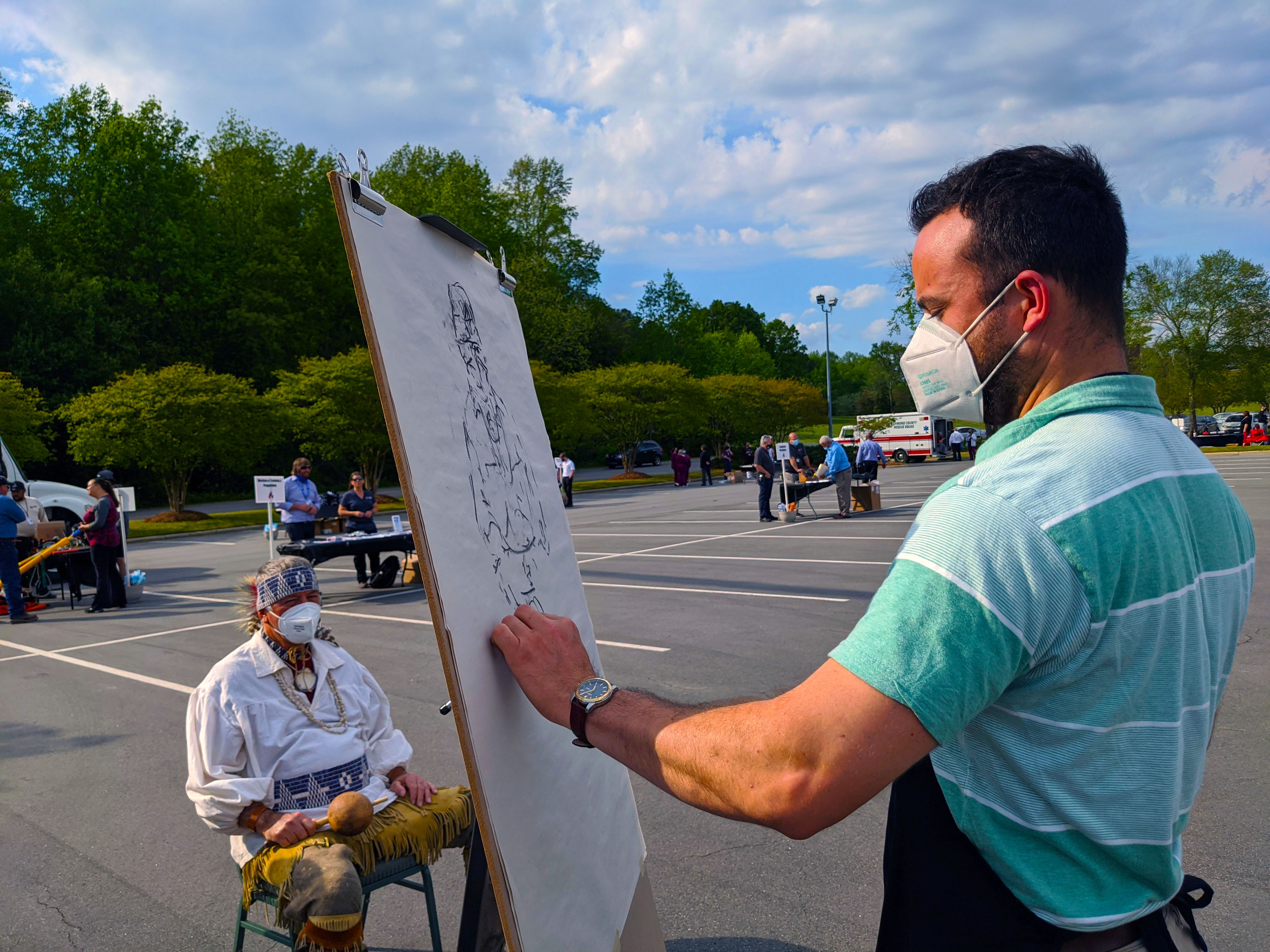 Art instructor Marcus Dunn sketches a photo with charcoal.