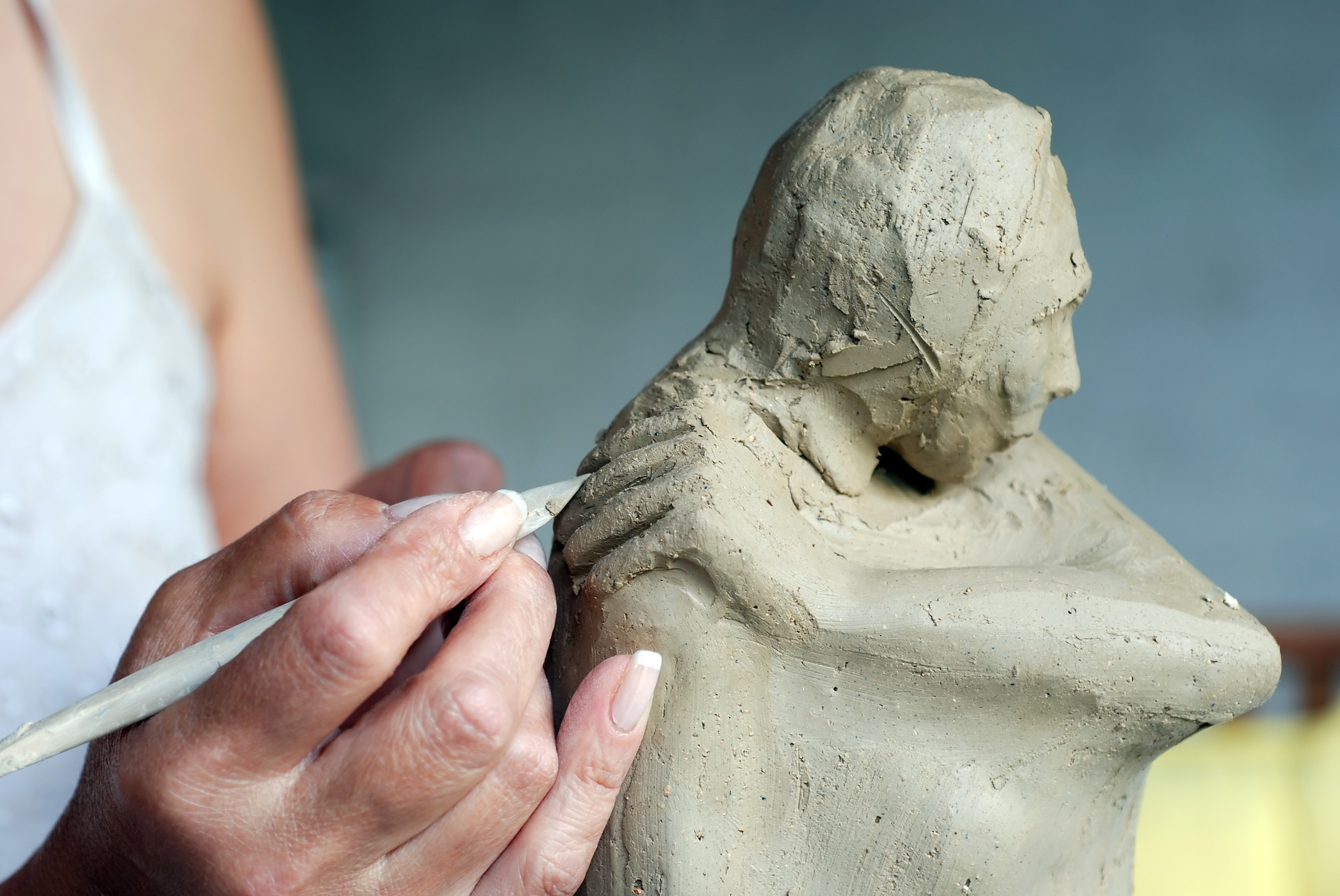 Person sculpting a figure