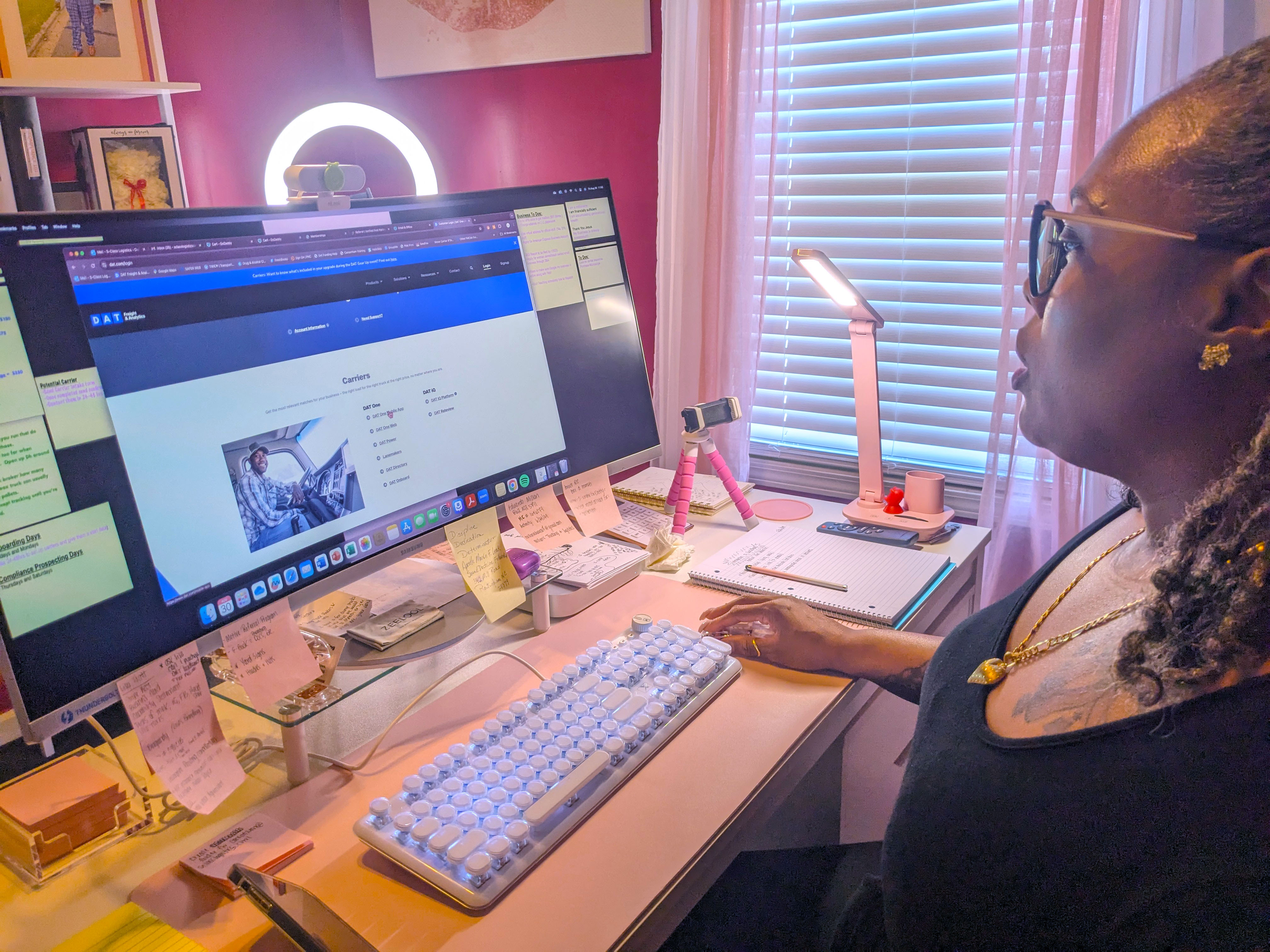 Freight dispatch company owner sits at her computer.