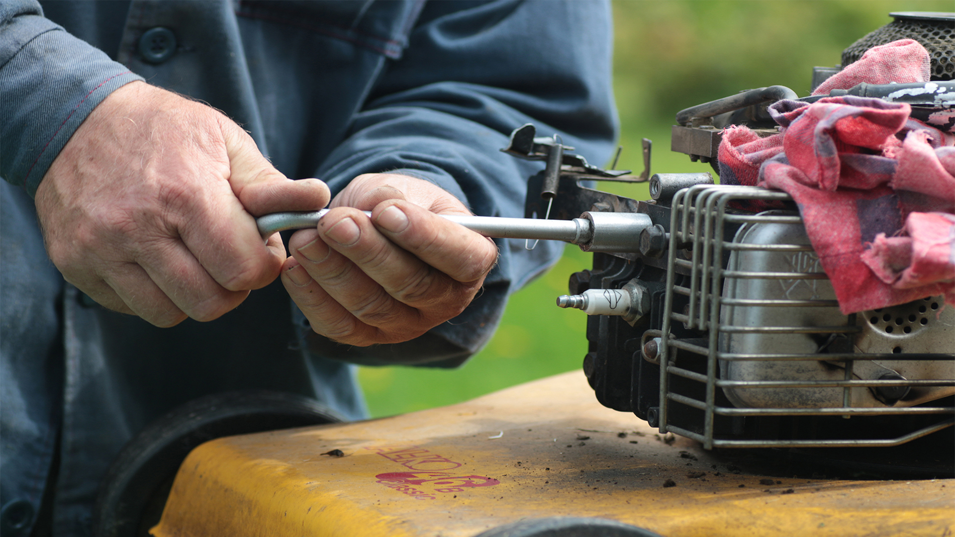 Photo of a person repairing a small engine.