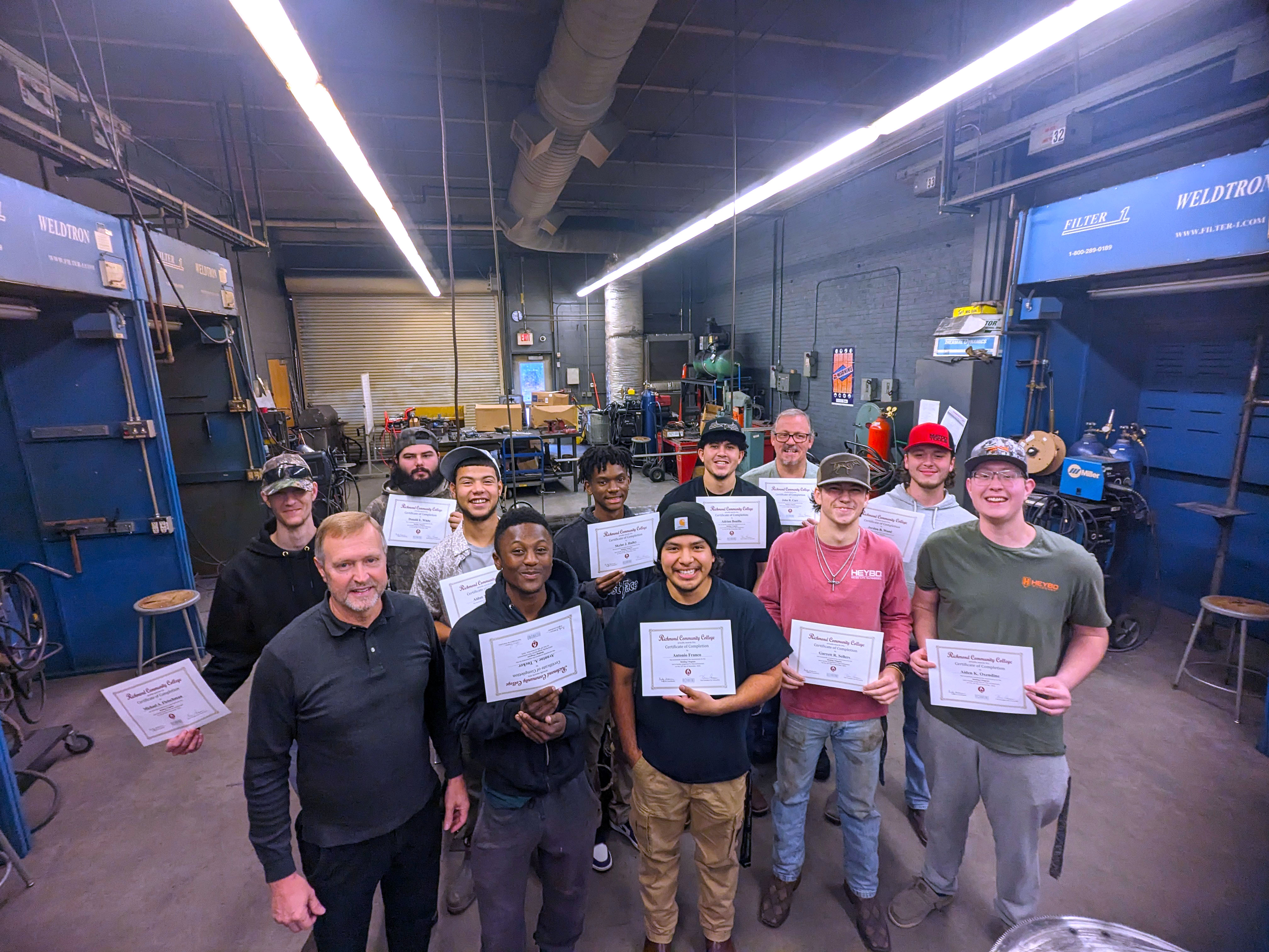 Welding graduates with instructor Ricky Freeman