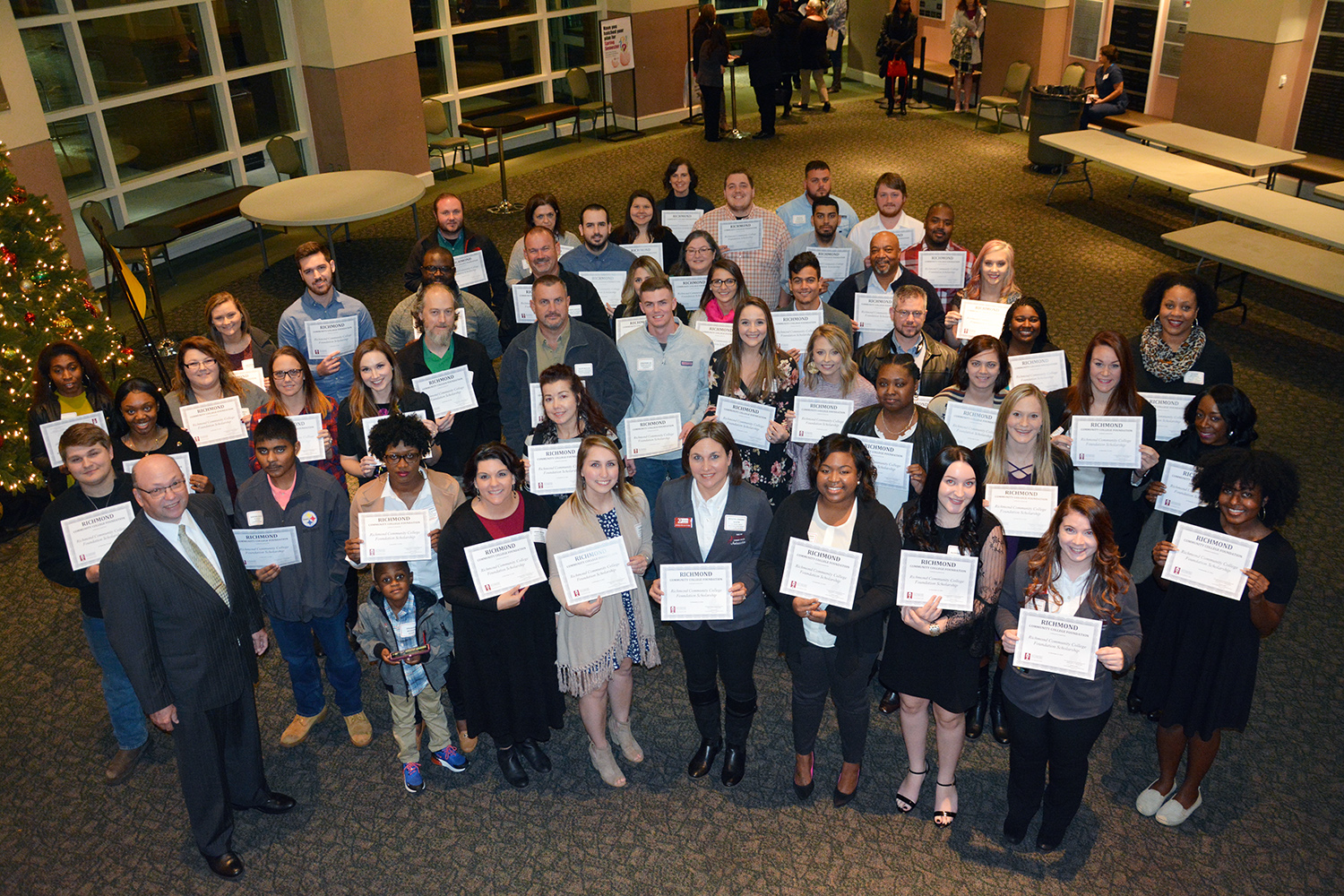 Working Student Scholarship students stand with College President