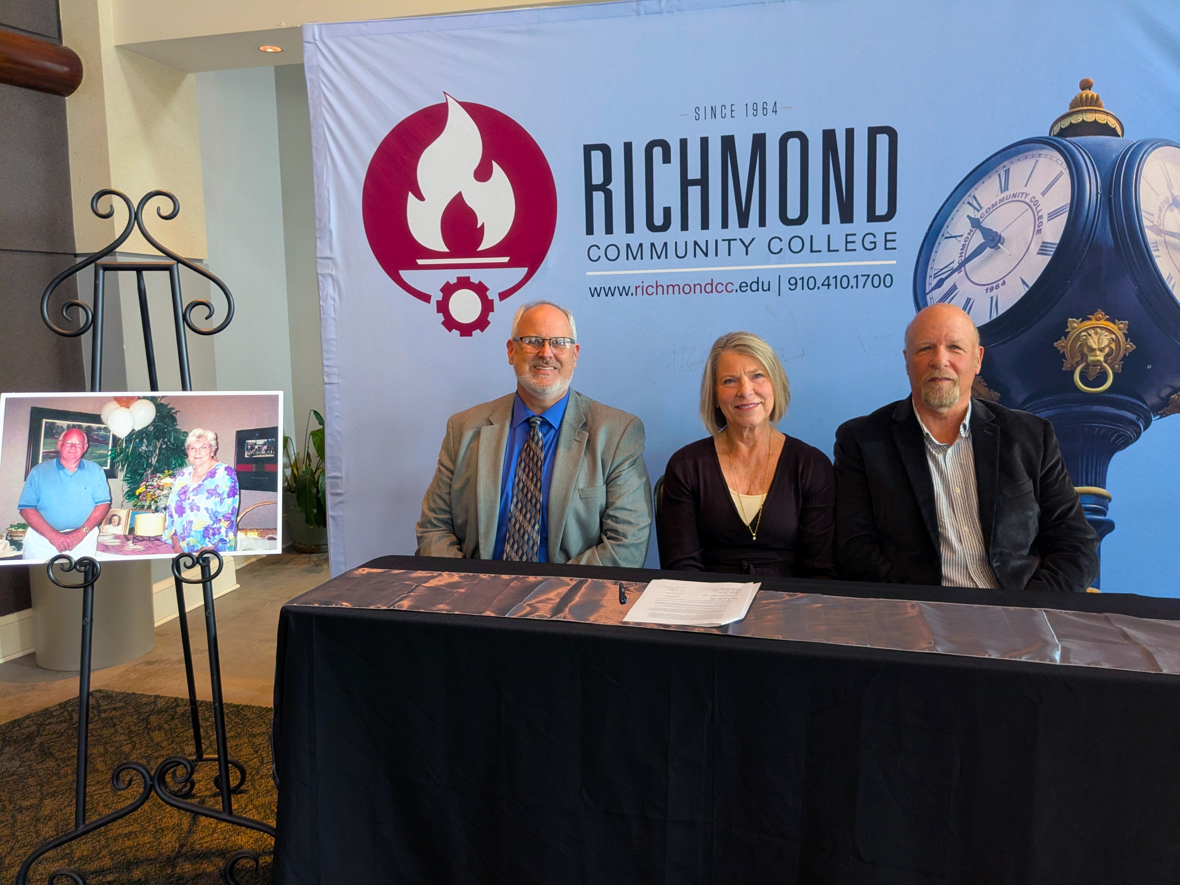 RichmondCC President sits with the scholarship donors at a table.