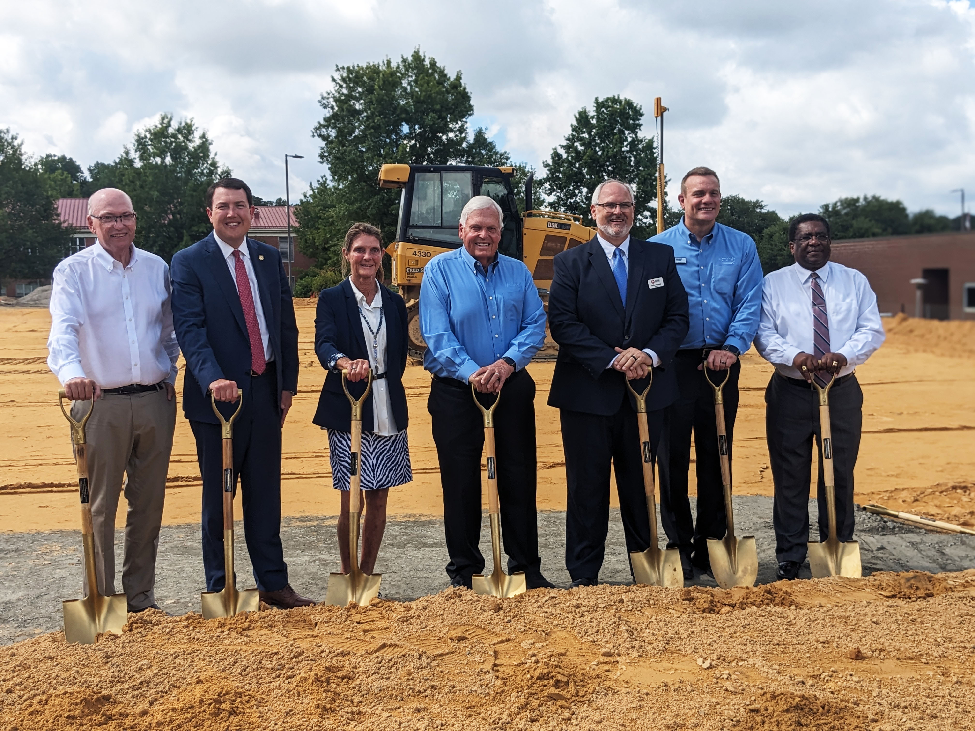 Hendrick and RCC leaders stand with shovels