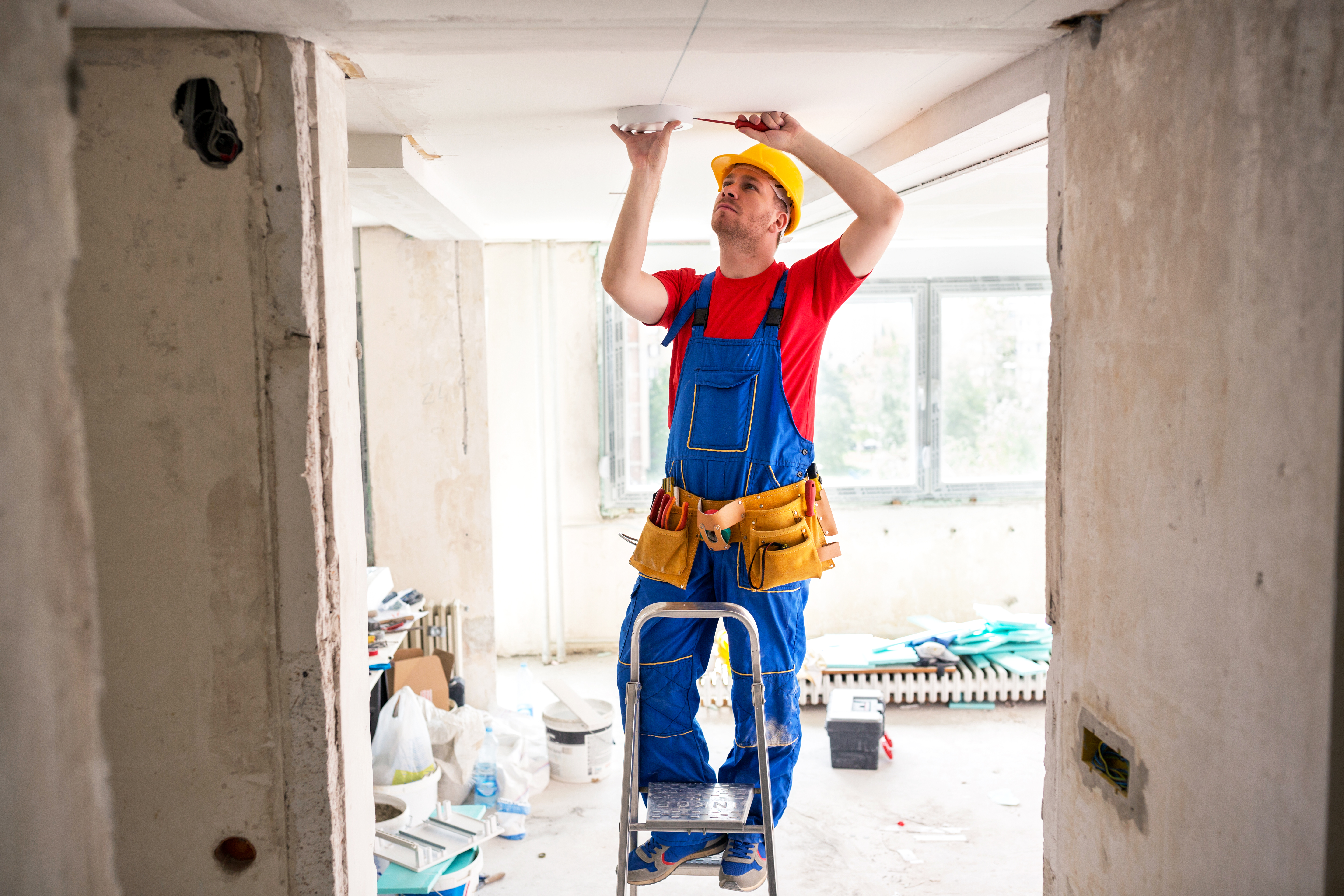 Electrician wiring a light in the ceiling