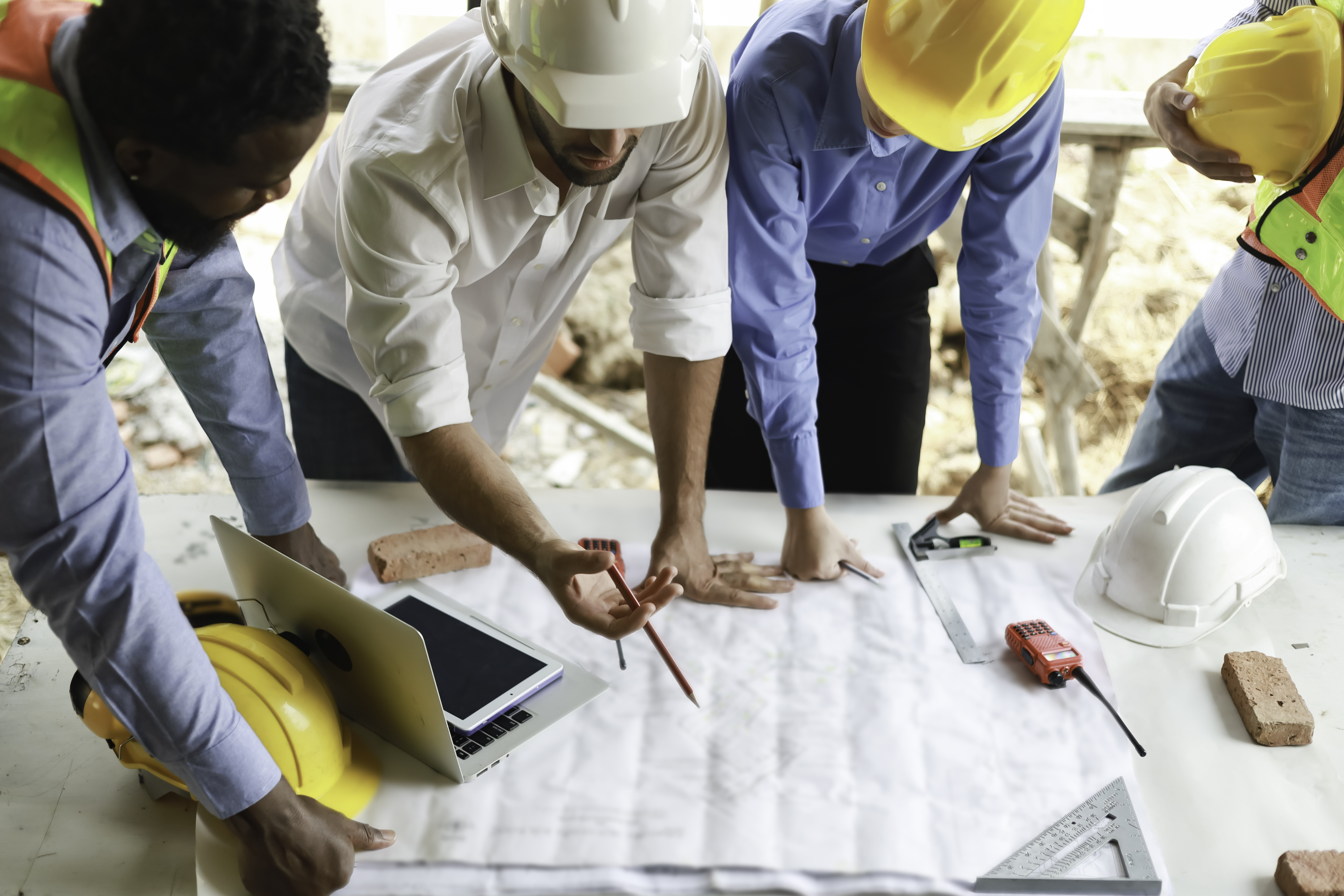 Construction crew goes over a construction drawing.