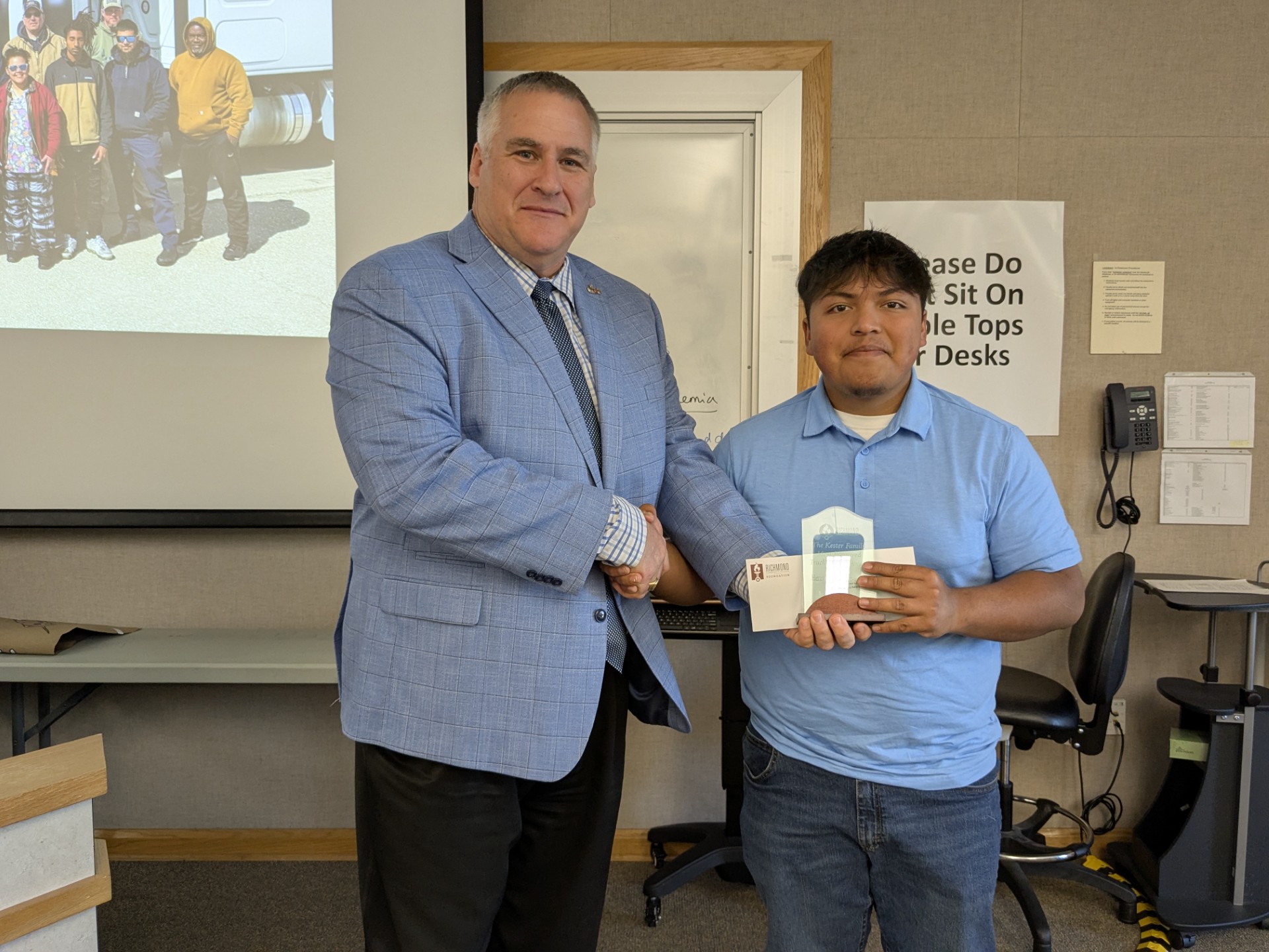 Dean presents student with a certificate.