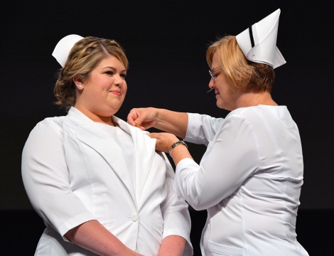 Nursing Dept. Chair Janet Sims pins a nursing student