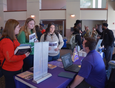 Students talking to college representative