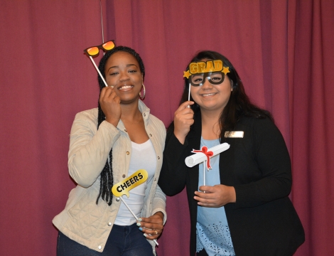 Students holding party favors celebrating graduation