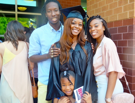 Graduate standing with family and friends