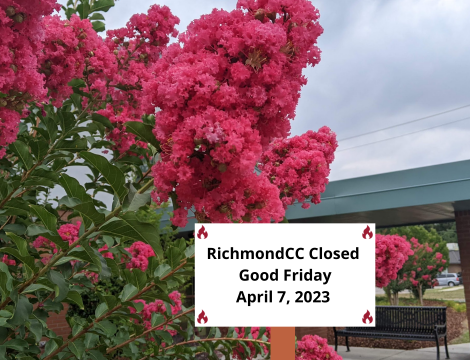 Pink flowers with sign noting college closed for Good Friday