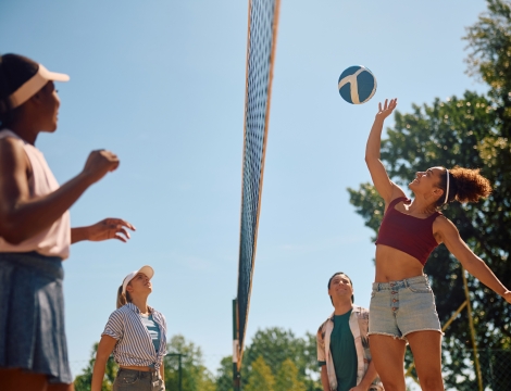 Photo of a volley ball player hitting a ball over the net