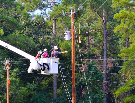 linemen in bucket working on powerline